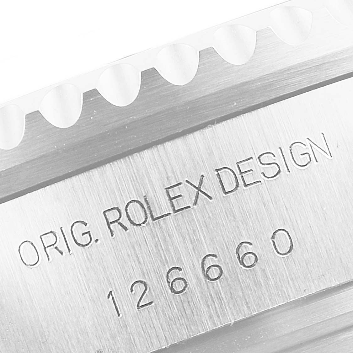 This close-up image shows the engraved model details and part of the bezel edge of a Rolex Sea-Dweller 126660 Men
s Stainless Steel Black Dial 126660 Men
s Stainless Steel Black Dial watch.