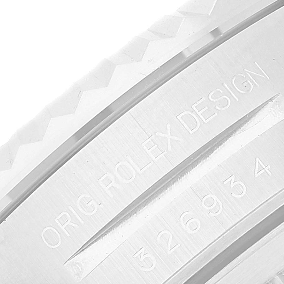 This close-up image shows the engraved text on the bezel of a Rolex Sky-Dweller 326934 Men's Stainless Steel White Dial 326934 Men's Stainless Steel White Dial watch at an angled perspective.