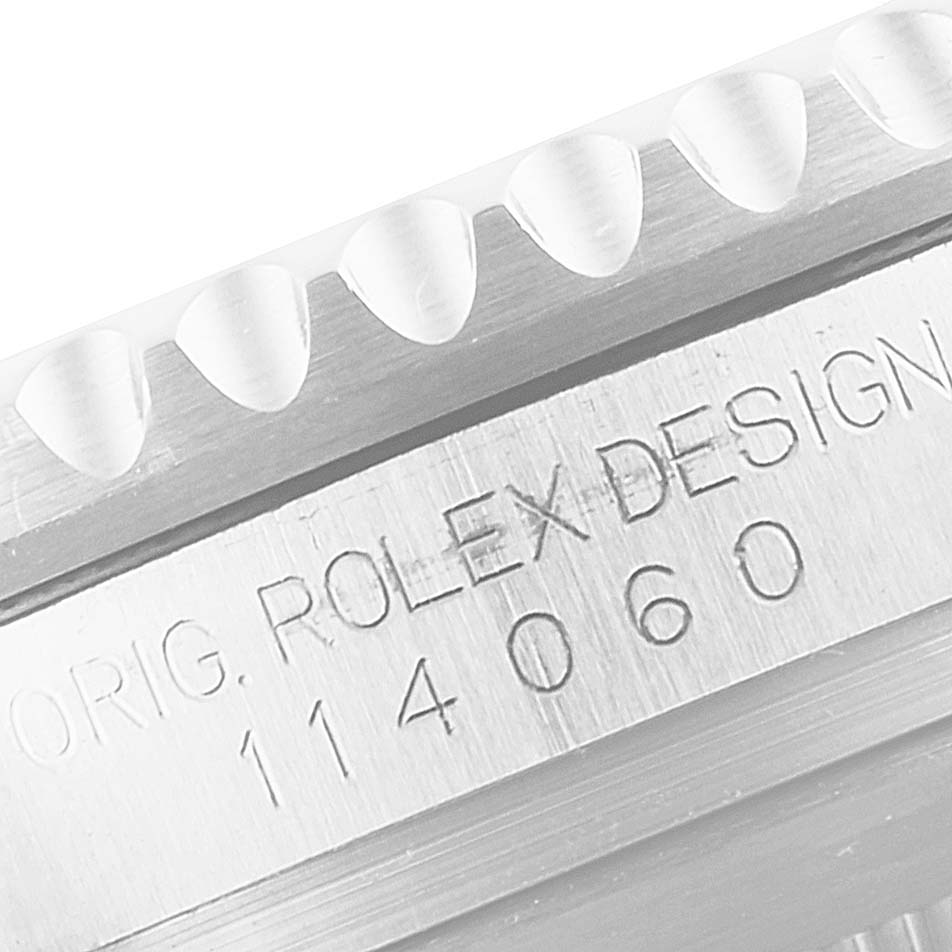 This image shows a close-up of the side of a Rolex Submariner 114060 Men
s Stainless Steel Black Dial 114060 Men
s Stainless Steel Black Dial watch case, highlighting the model number 114060 and the bezel edge.