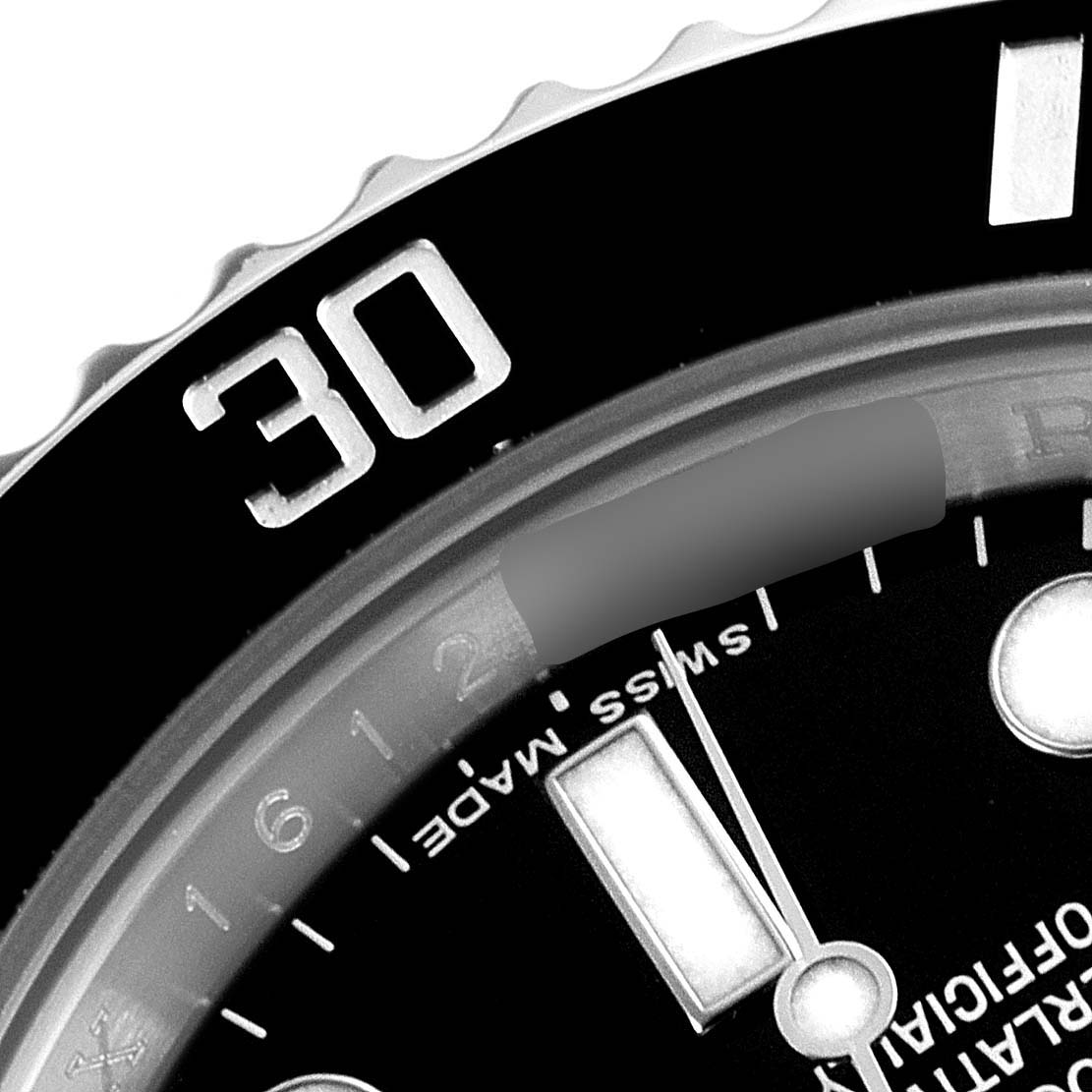 This close-up image of a Rolex Submariner 116610 Men
s Stainless Steel Black Dial 116610 Men
s Stainless Steel Black Dial watch shows part of the black bezel, minute markers, and the "Swiss Made" text.