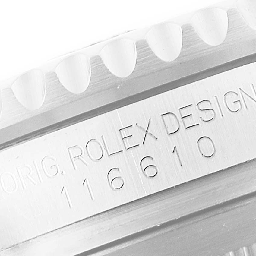 This close-up image shows the engraved model number and part of the bezel edge of a Rolex Submariner 116610LN Men
s Stainless Steel Black Dial 116610LN Men
s Stainless Steel Black Dial watch.