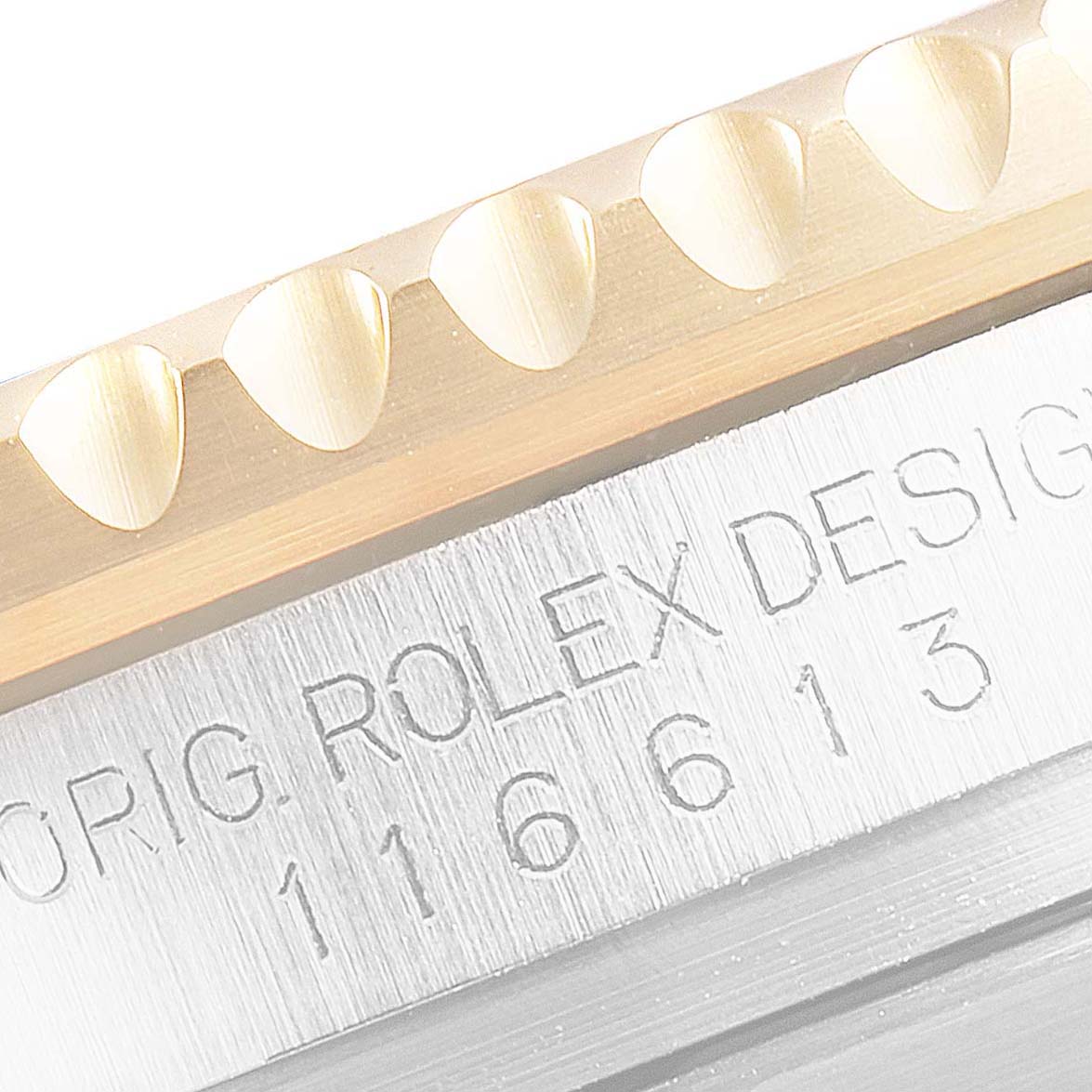 The image shows a close-up of the serial number and part of the bezel of a Rolex Submariner 116613 Men's Steel and Gold (two tone) Black Dial 116613 Men's Steel and Gold (two tone) Black Dial watch.