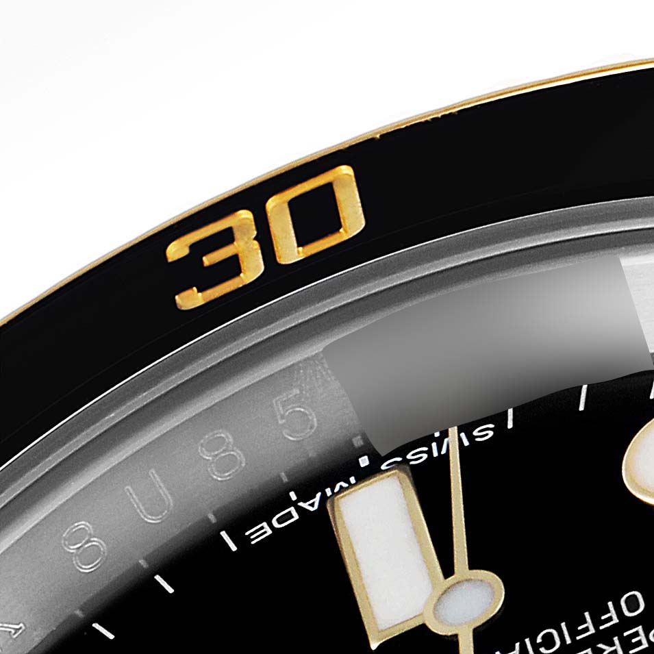 The close-up image shows part of the bezel, dial, and hands of the Rolex Submariner 116613 Men's Steel and Gold (two tone) Black Dial 116613 Men's Steel and Gold (two tone) Black Dial watch.