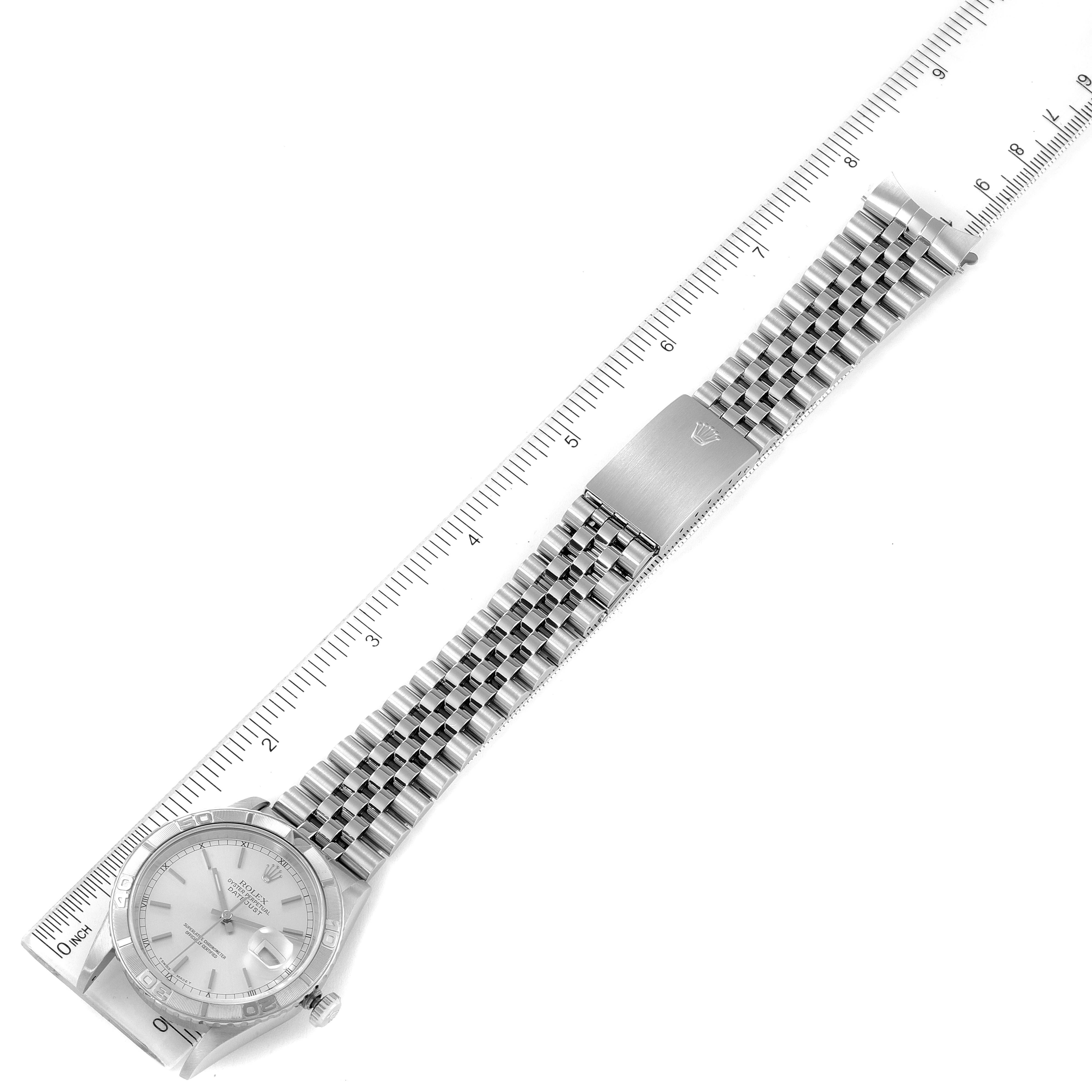 This image shows the entire Rolex Turn-o-Graph 16264 Men
s Stainless Steel Silver Dial 16264 Men
s Stainless Steel Silver Dial watch placed diagonally, measured with a ruler beside it.