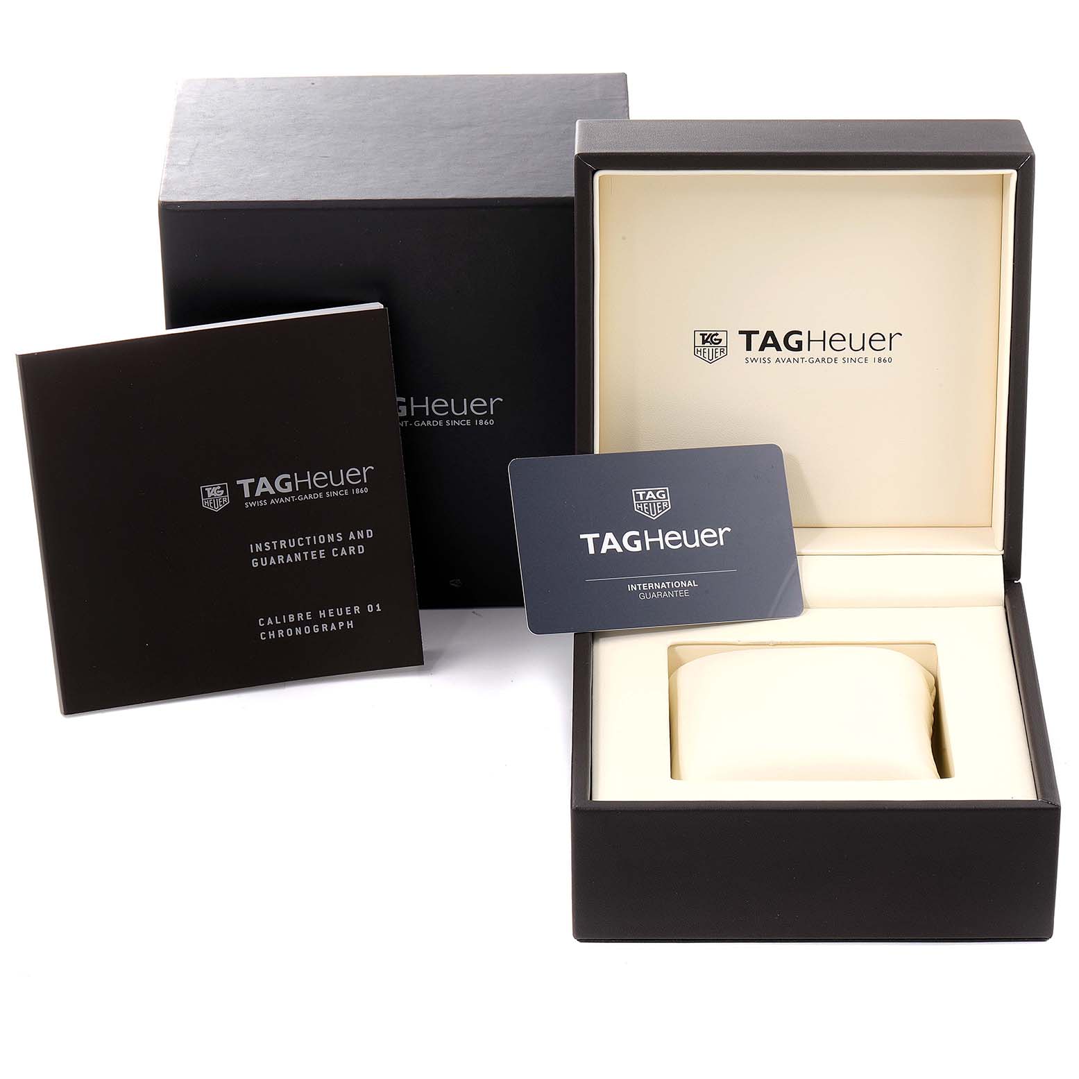 The image shows the packaging, instruction manual, guarantee card, and watch box of the Tag Heuer Carrera CAR201W.BA0714 Men's Stainless Steel Black Dial CAR201W.BA0714 Men's Stainless Steel Black Dial model.