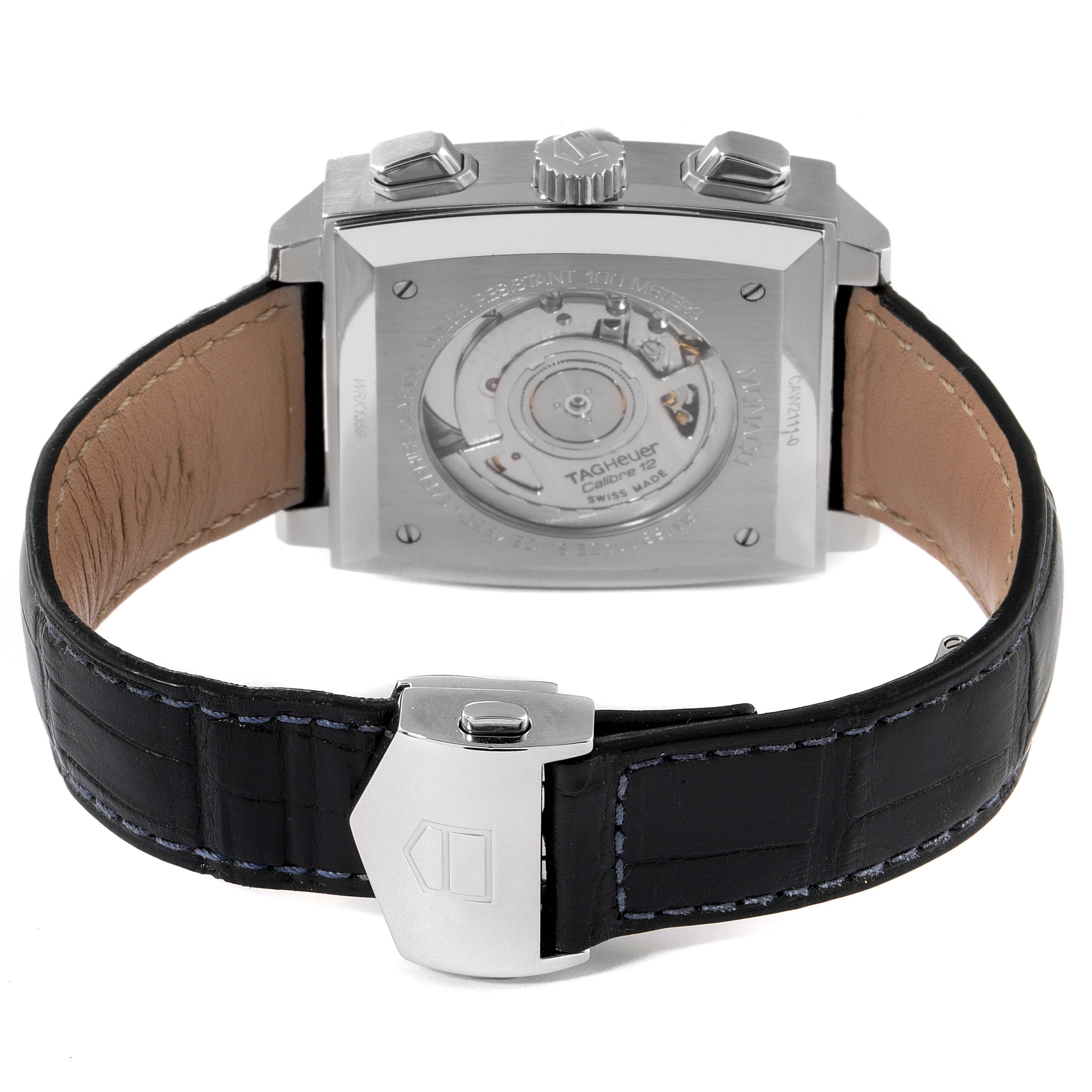 The image shows the back of a Tag Heuer Monaco CAW2111 Men's Stainless Steel Blue Dial CAW2111 Men's Stainless Steel Blue Dial watch, highlighting the exposed movement, leather strap, and clasp.