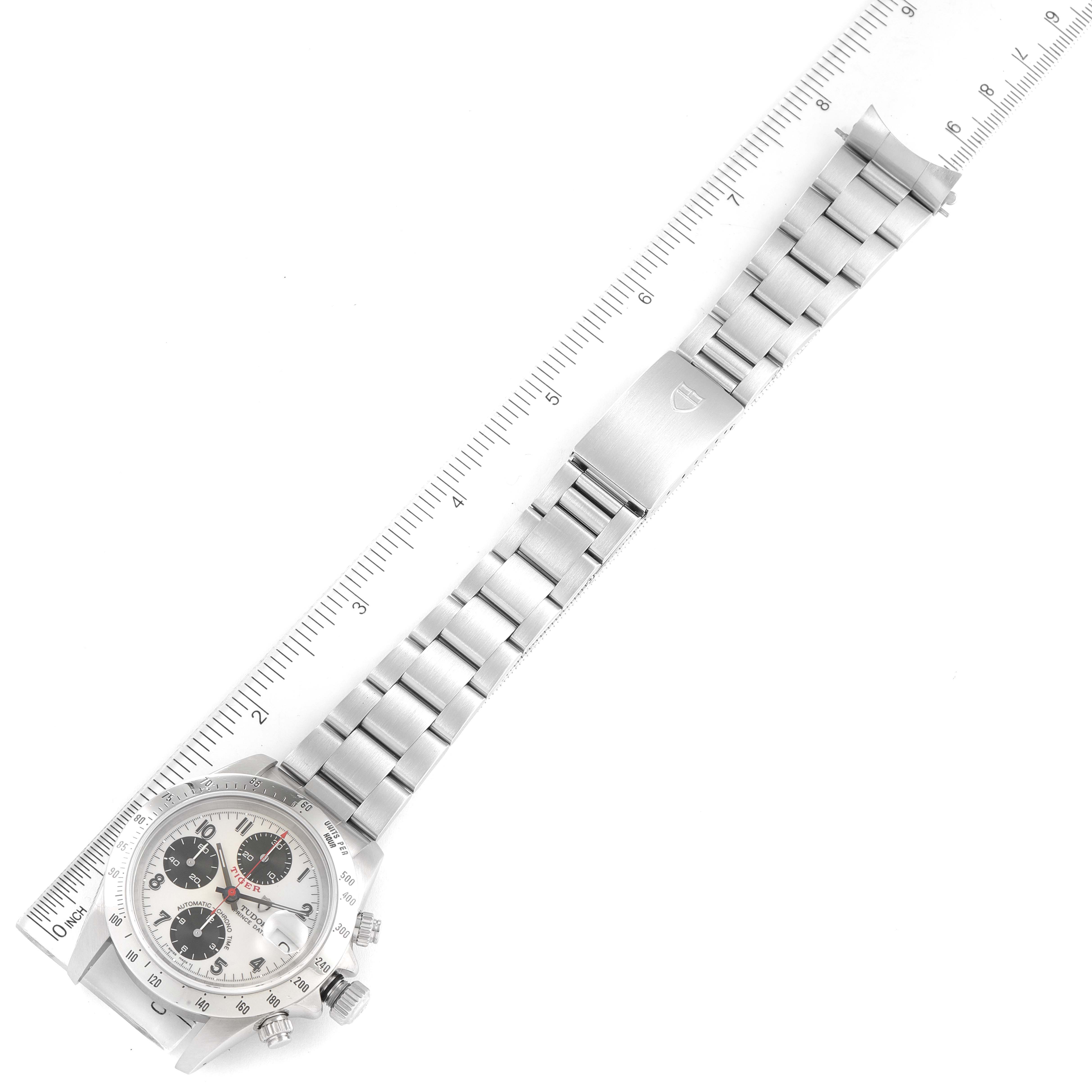 The image shows a Tudor Prince model watch with a metal bracelet laid next to a ruler, displaying the dial, bezel, and bracelet in a top-down view.