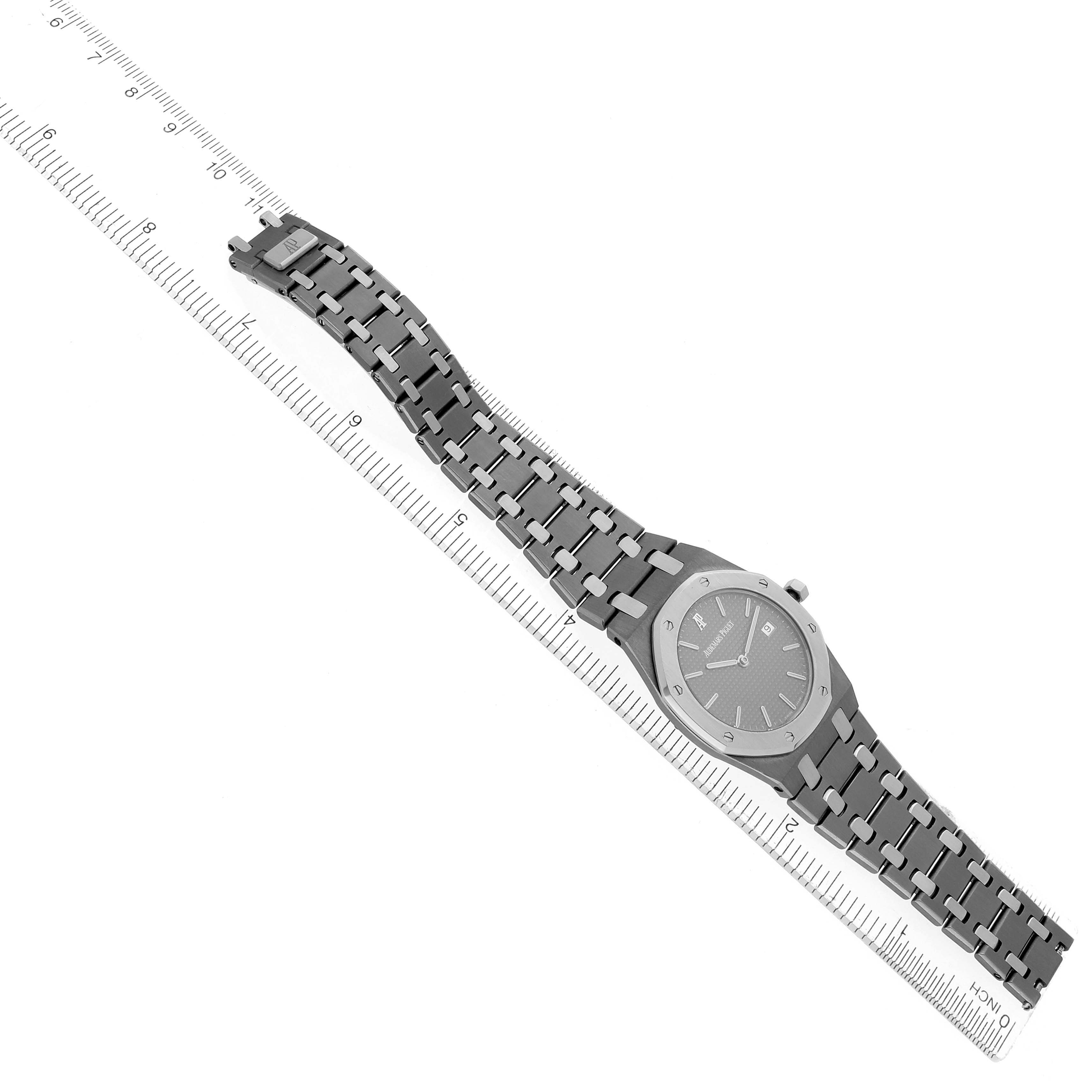 The Audemars Piguet Royal Oak 56175TT Men's Stainless Steel Grey Dial watch is shown at a diagonal angle with full view of its case and bracelet against a ruler.