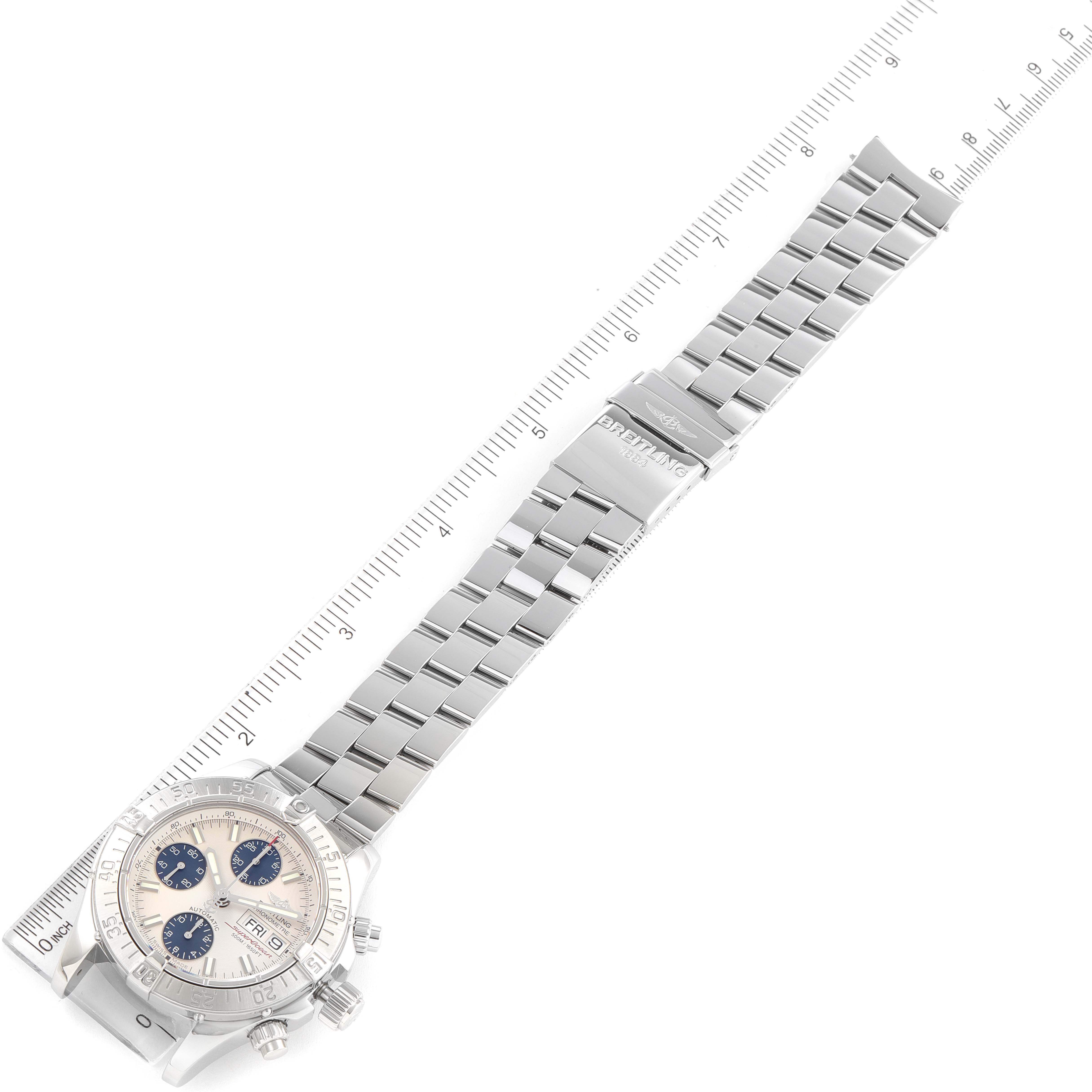 The image shows the Superocean model by Breitling from a top-down angle, displaying the watch face, bracelet, and clasp.