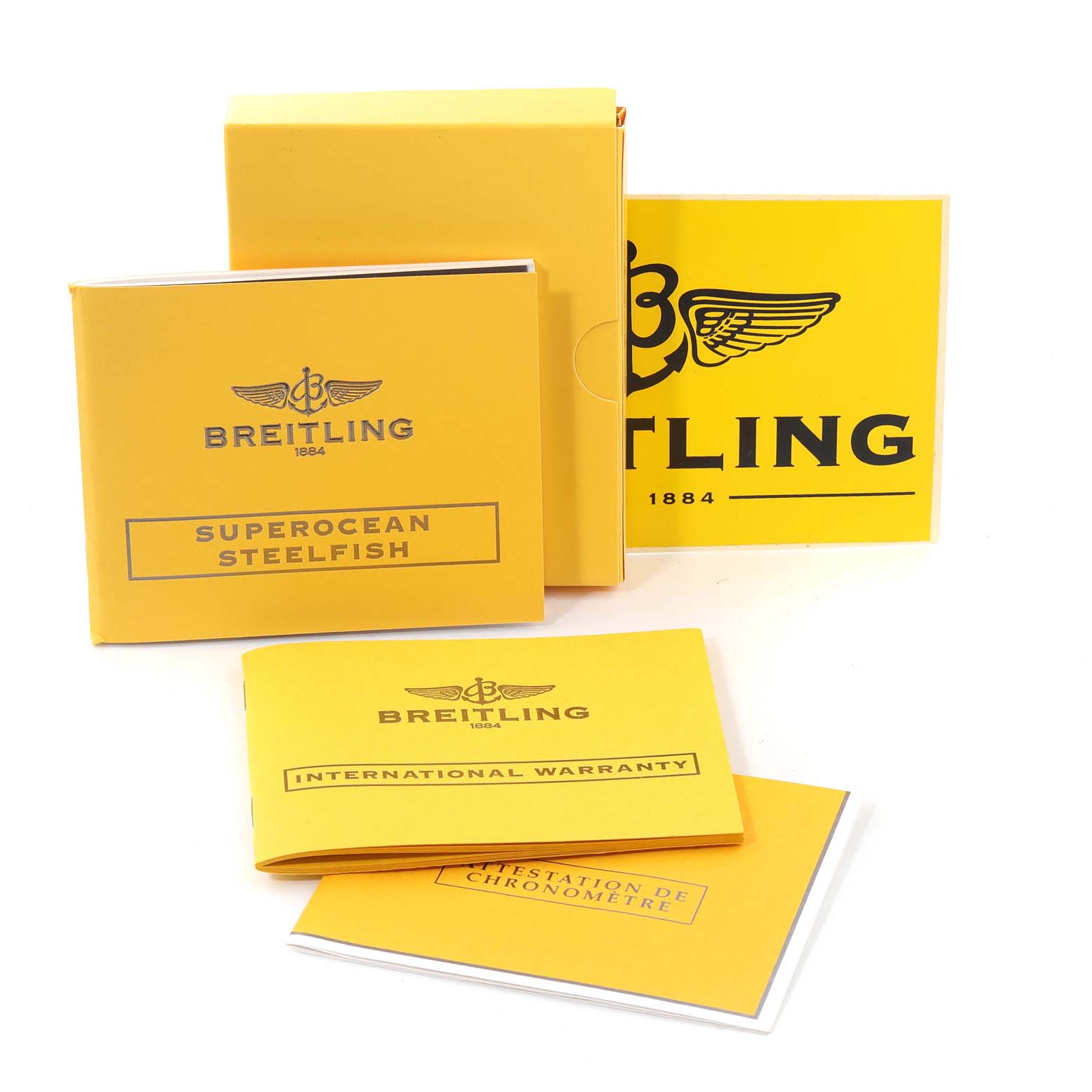 The image shows Breitling Superocean A17390 Men's Stainless Steel Silver Dial A17390 Men's Stainless Steel Silver Dial model manuals and warranty booklets from various angles.