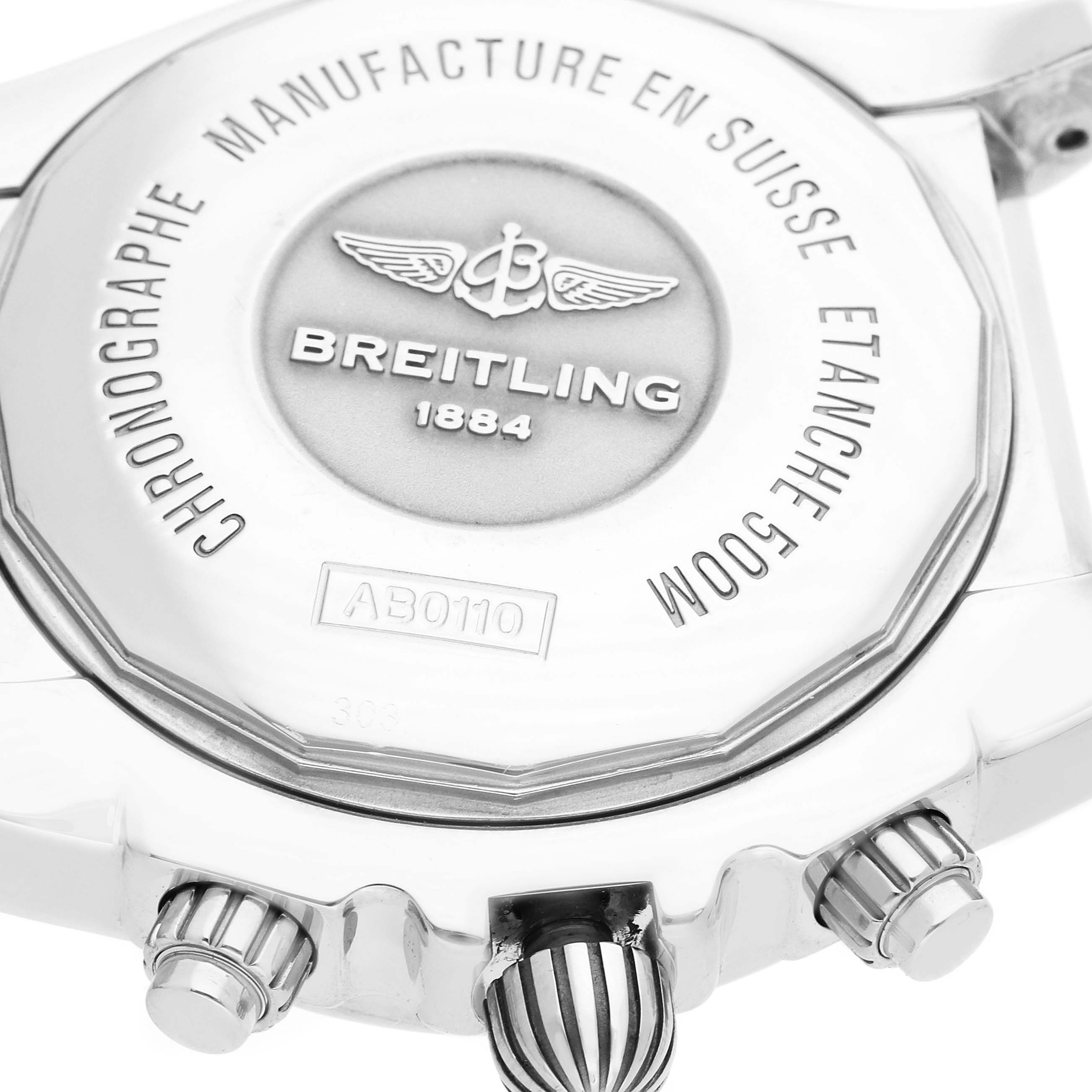 The image shows the back case and crown of the Breitling Chronomat AB0110/A011C89PA Men's Stainless Steel Blue Dial watch from an angle highlighting its engraving and buttons.