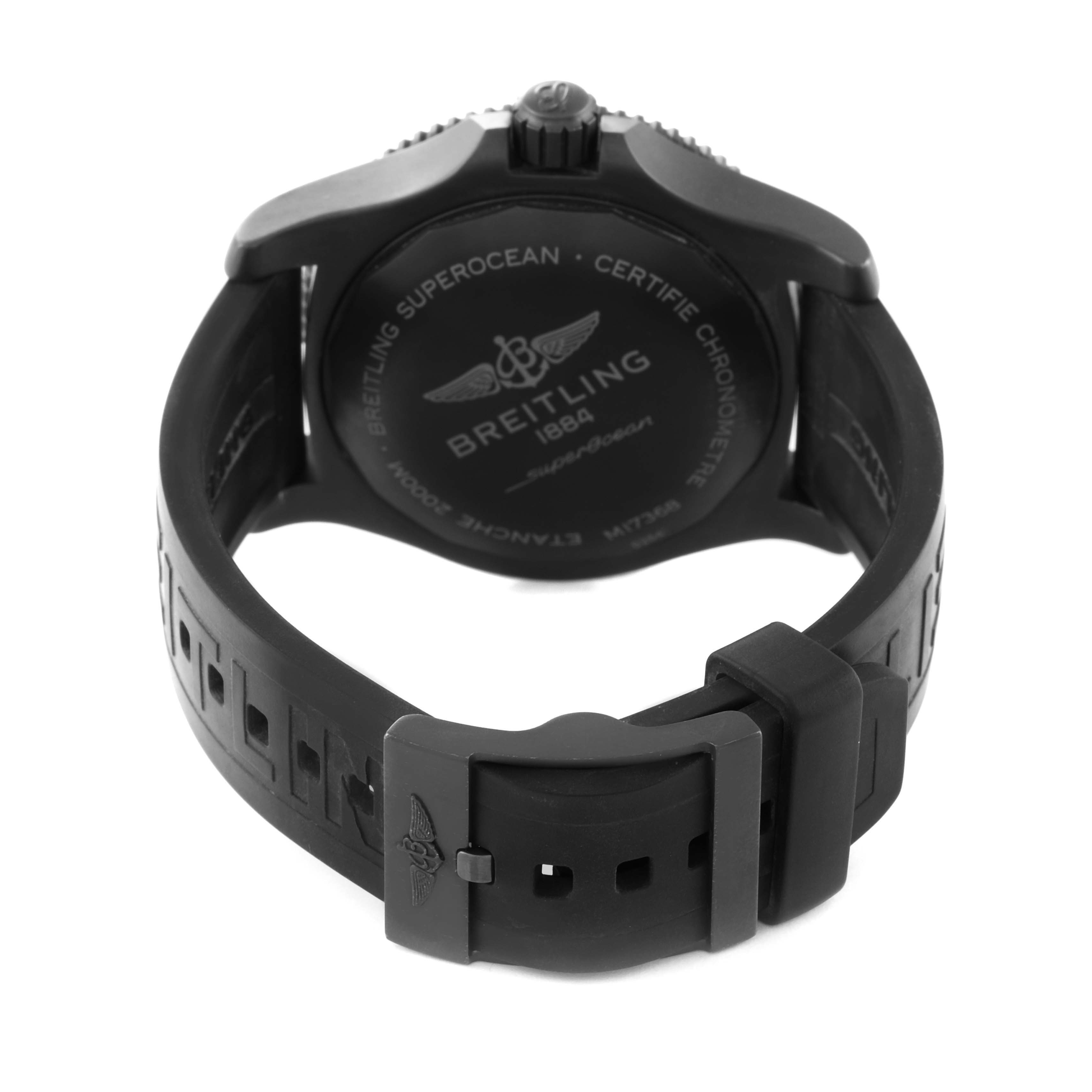The Breitling Superocean M17368 Men's Stainless Steel Black Dial watch is shown from the back, highlighting the case back and rubber strap with buckle.