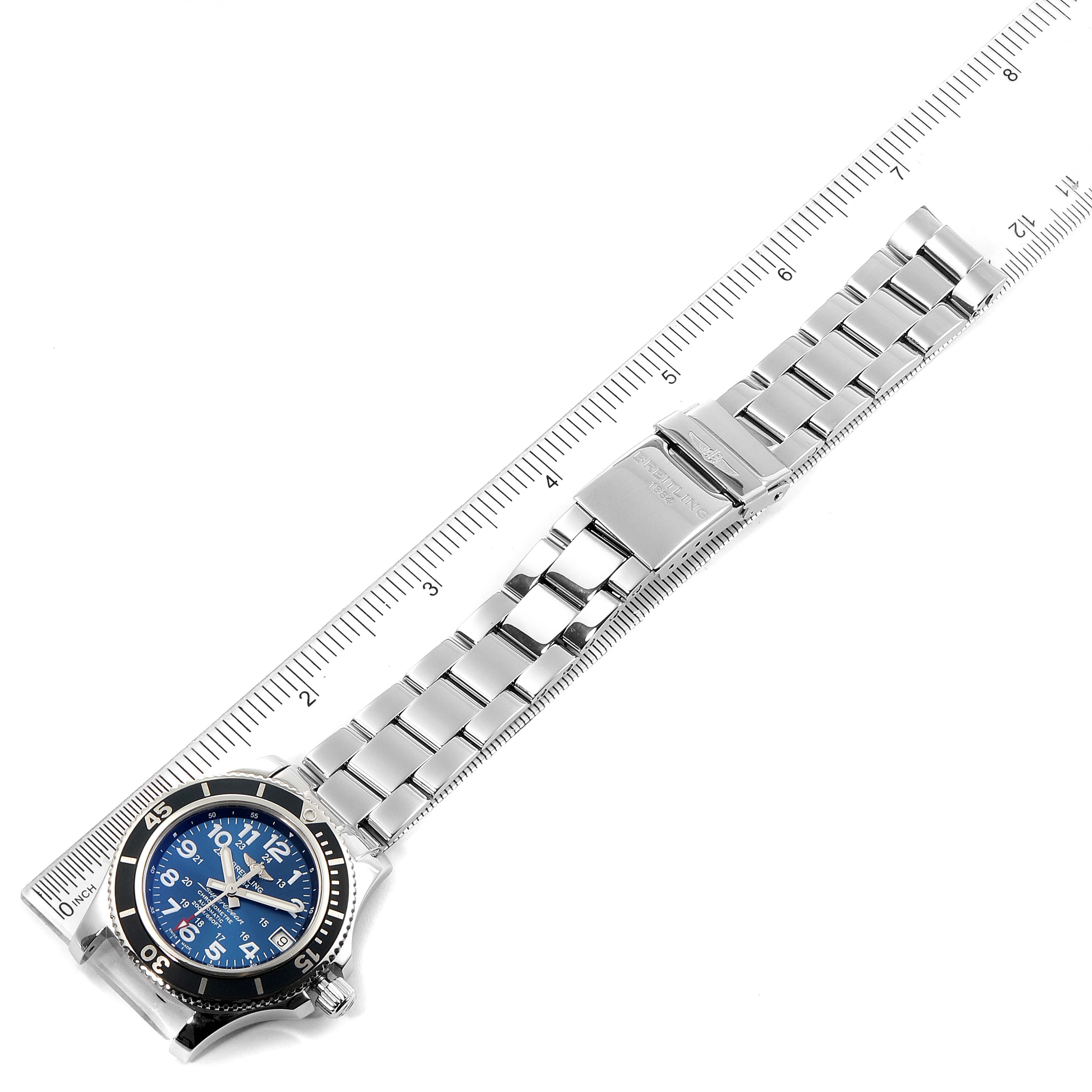 The image shows a Breitling A17312 Women's Stainless Steel Blue Dial A17312 Women's Stainless Steel Blue Dial Superocean II 36 Hurricane Steel Ladies Watch A17312 laying flat with a ruler beside it.