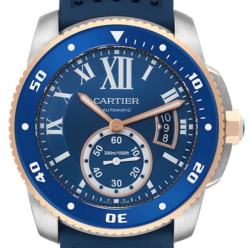 The Calibre de Cartier watch is shown from a front angle, highlighting its blue dial, bezel, hands, and Roman numerals.