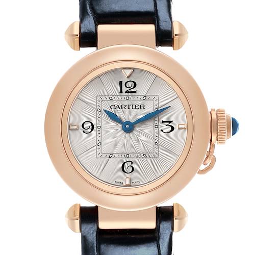 The Cartier Pasha WGPA0018 Women's Rose Gold Silver Dial watch is shown from the front, featuring its round dial, blue hands, distinctive crown with a blue accent, and a leather strap.