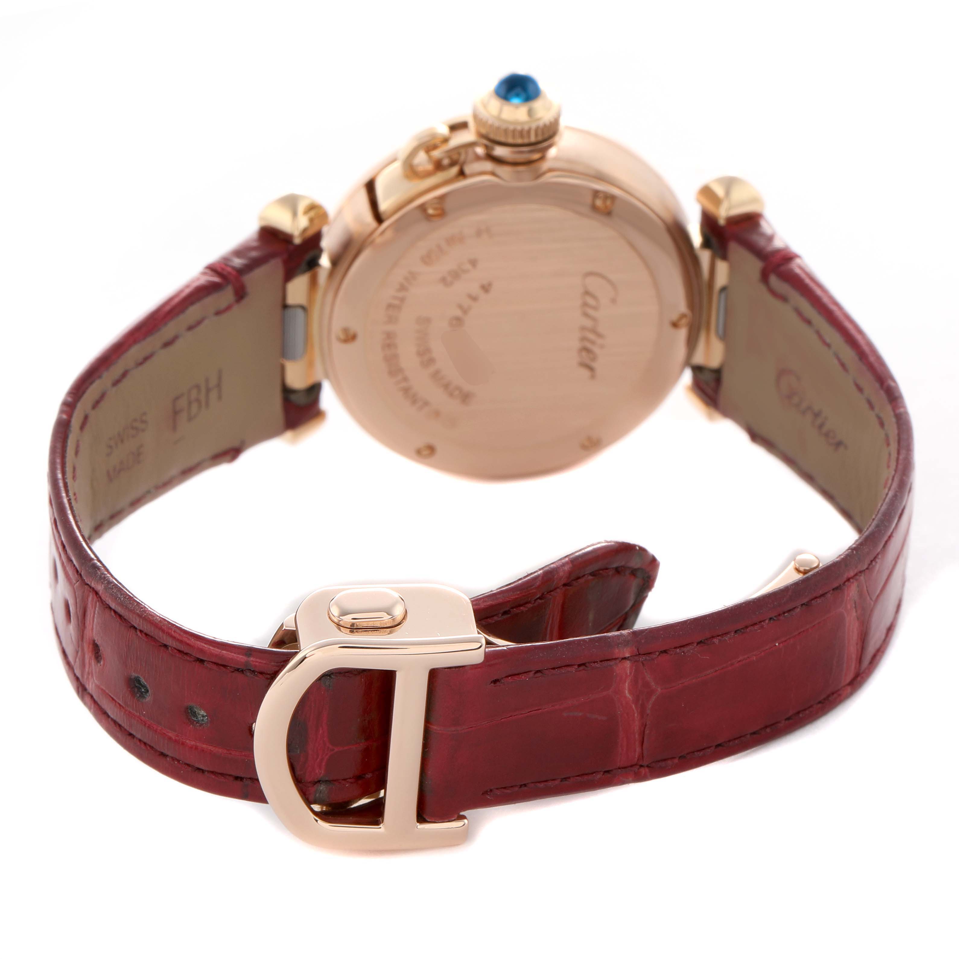 The image shows the back of a Cartier Pasha WJPA0017 Women's Rose Gold Silver Dial watch, focusing on the case back, crown, and burgundy leather strap with a deployant clasp.