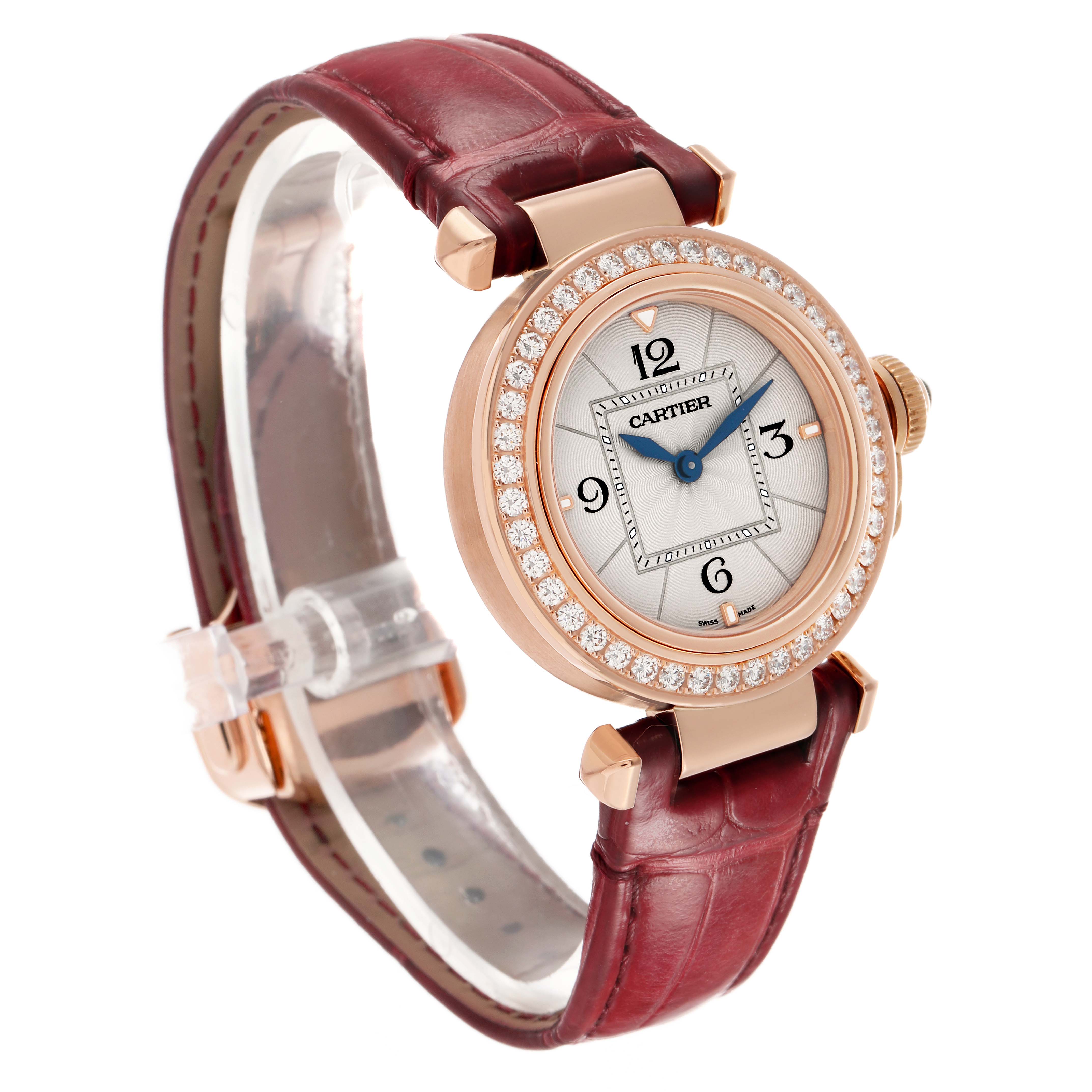 The Cartier Pasha WJPA0017 Women's Rose Gold Silver Dial watch is shown from a three-quarter angle, highlighting its diamond bezel, dial, and burgundy leather strap.