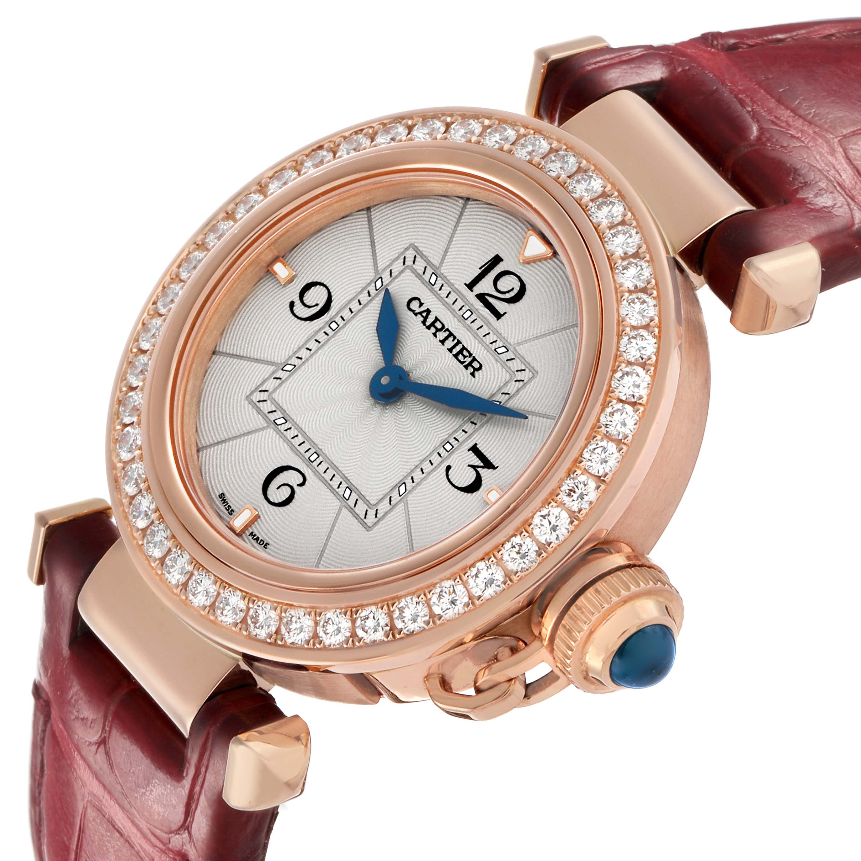 The Cartier Pasha WJPA0017 Women's Rose Gold Silver Dial watch is shown from a slightly angled top view, highlighting the jeweled bezel and crown with a leather strap.
