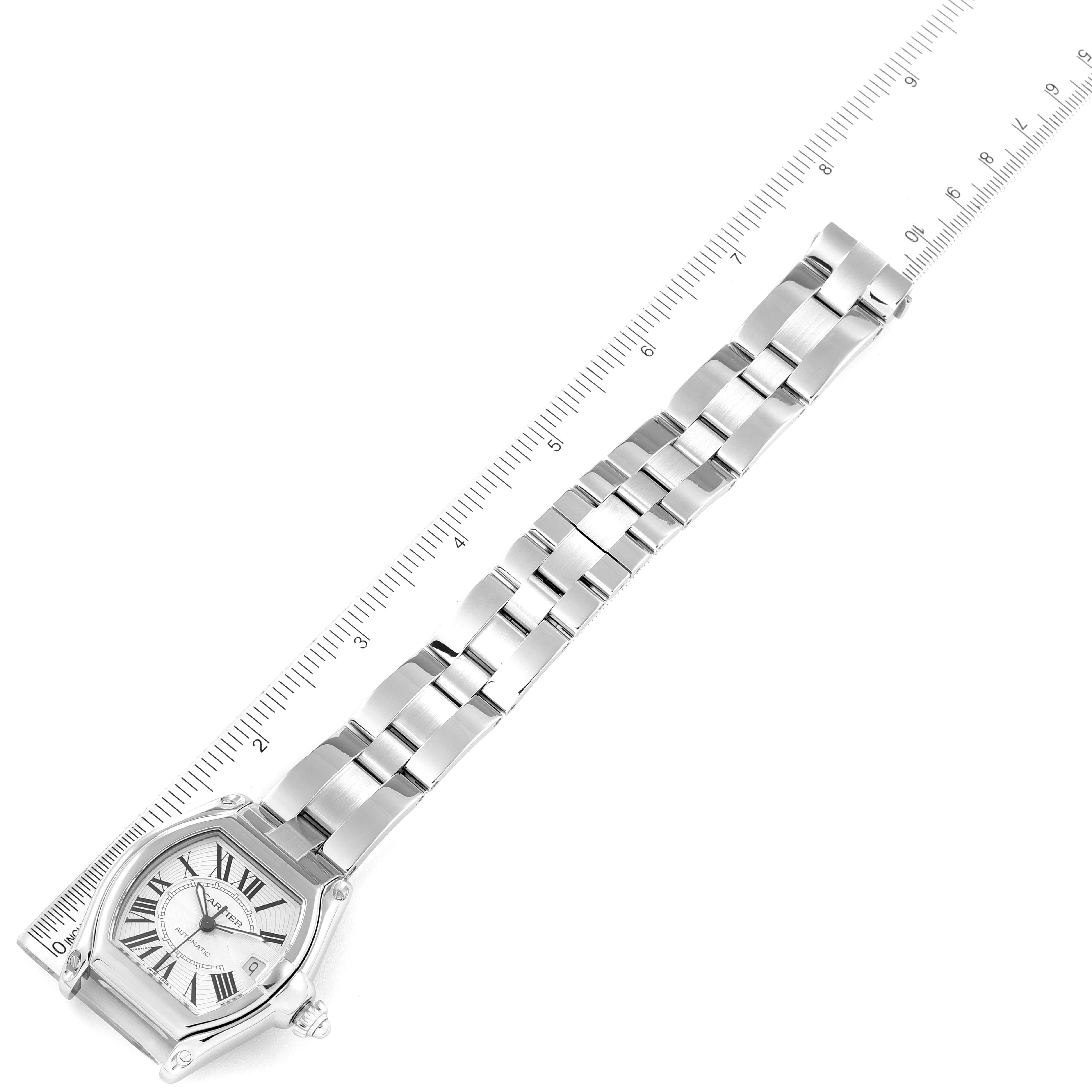A Cartier Roadster W62025V3 Men's Stainless Steel Silver Dial W62025V3 Men's Stainless Steel Silver Dial watch is shown at an angle, featuring the face, bracelet, and ruler for scale.