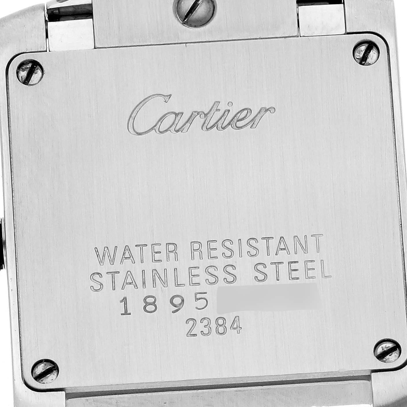 The image shows the back case of the Cartier Tank Française watch with engraved details.