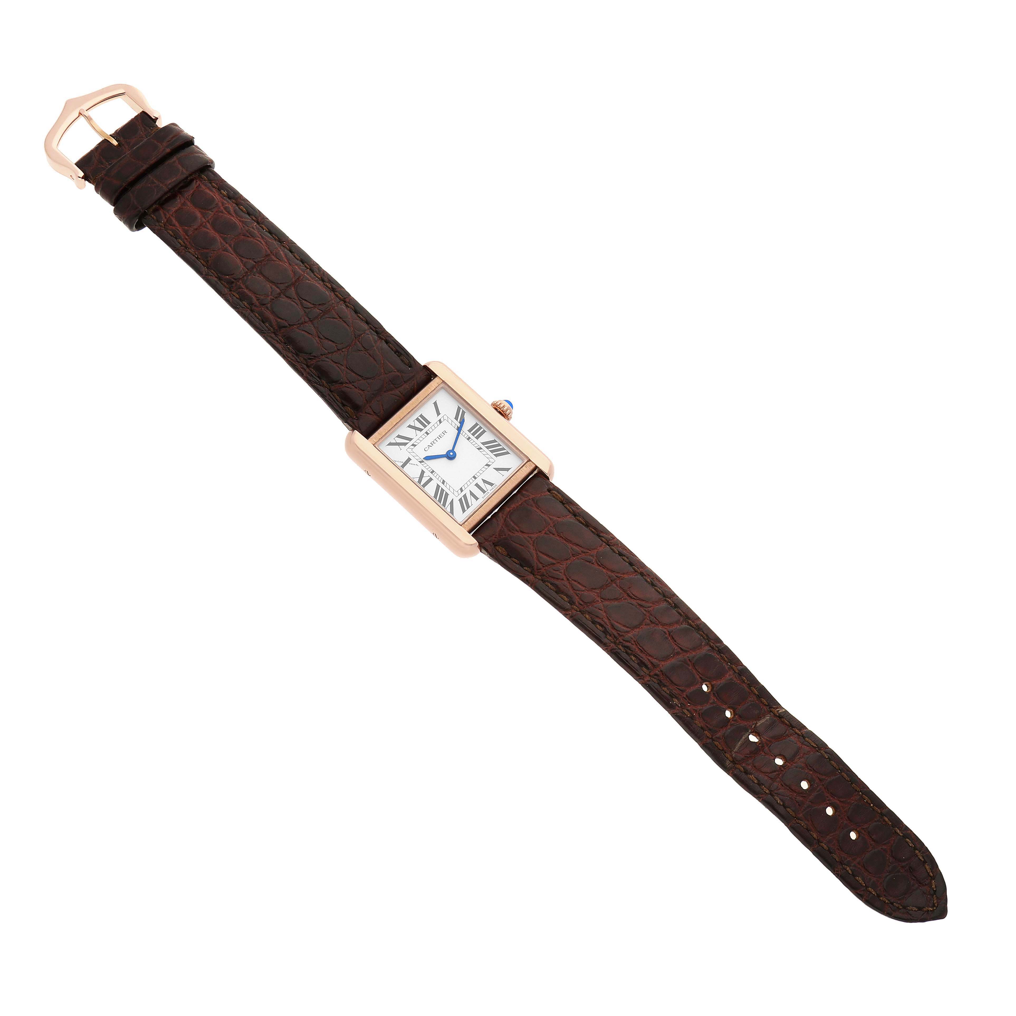 The Cartier Tank Solo W5200024 Women's Rose Gold Silver Dial watch is shown from a top-down angle, displaying its rectangular face, brown leather strap, and buckle.