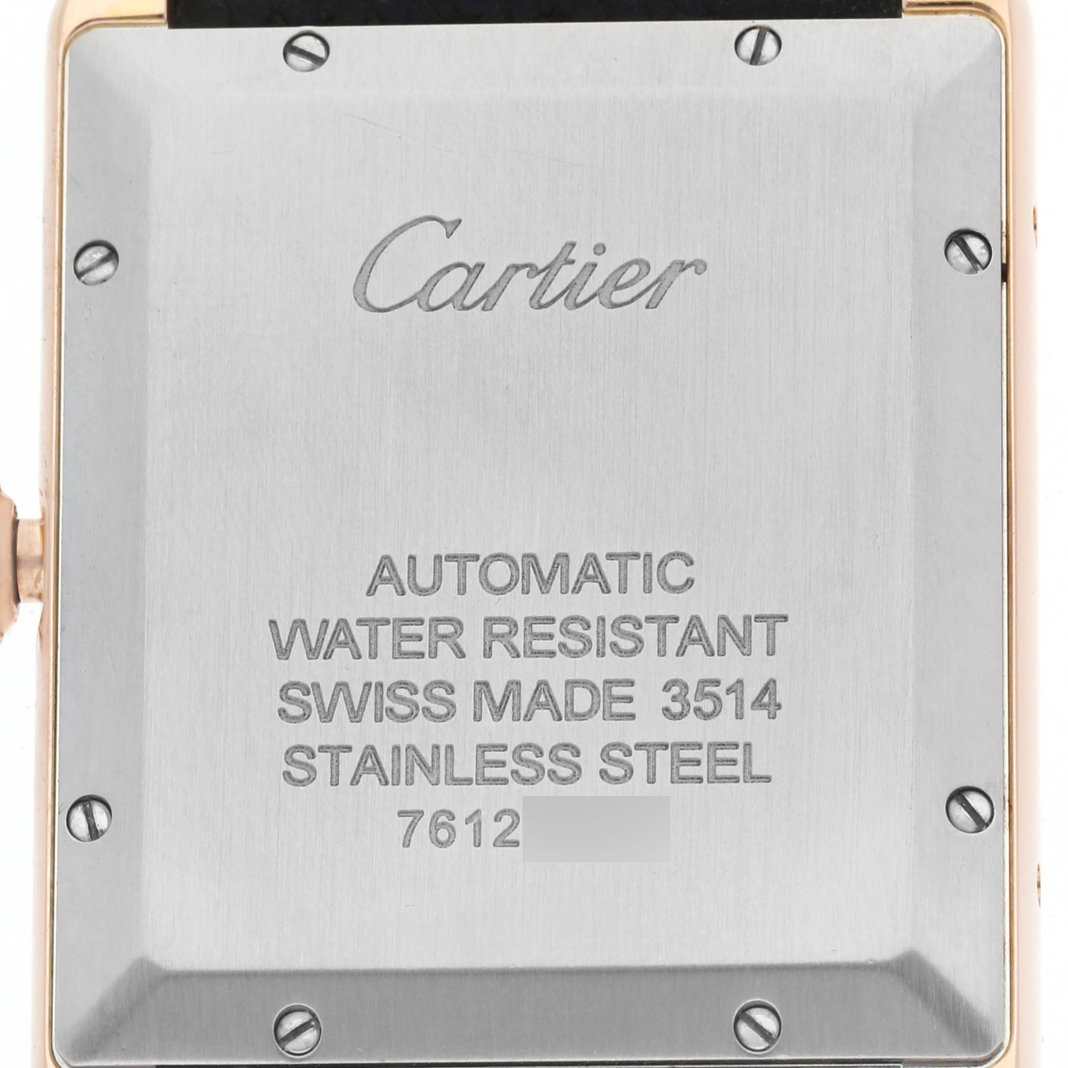 The image shows the back of a Cartier Tank Solo W5200026 Men's Rose Gold Silver Dial watch, highlighting its stainless steel case and engraved details.