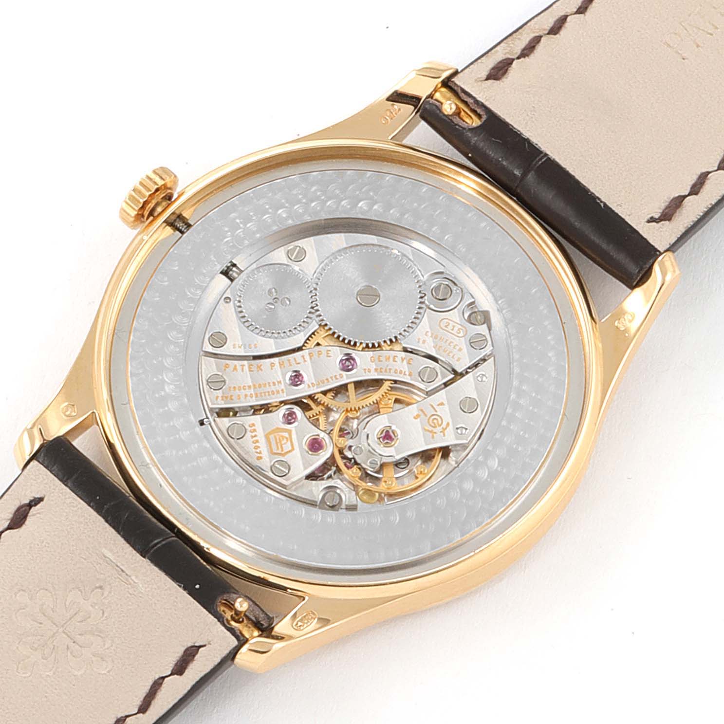 The image shows the intricate movement and case back of a Patek Philippe Calatrava 5196J Men's Yellow Gold Silver Dial 5196J Men's Yellow Gold Silver Dial watch, viewed from the rear.