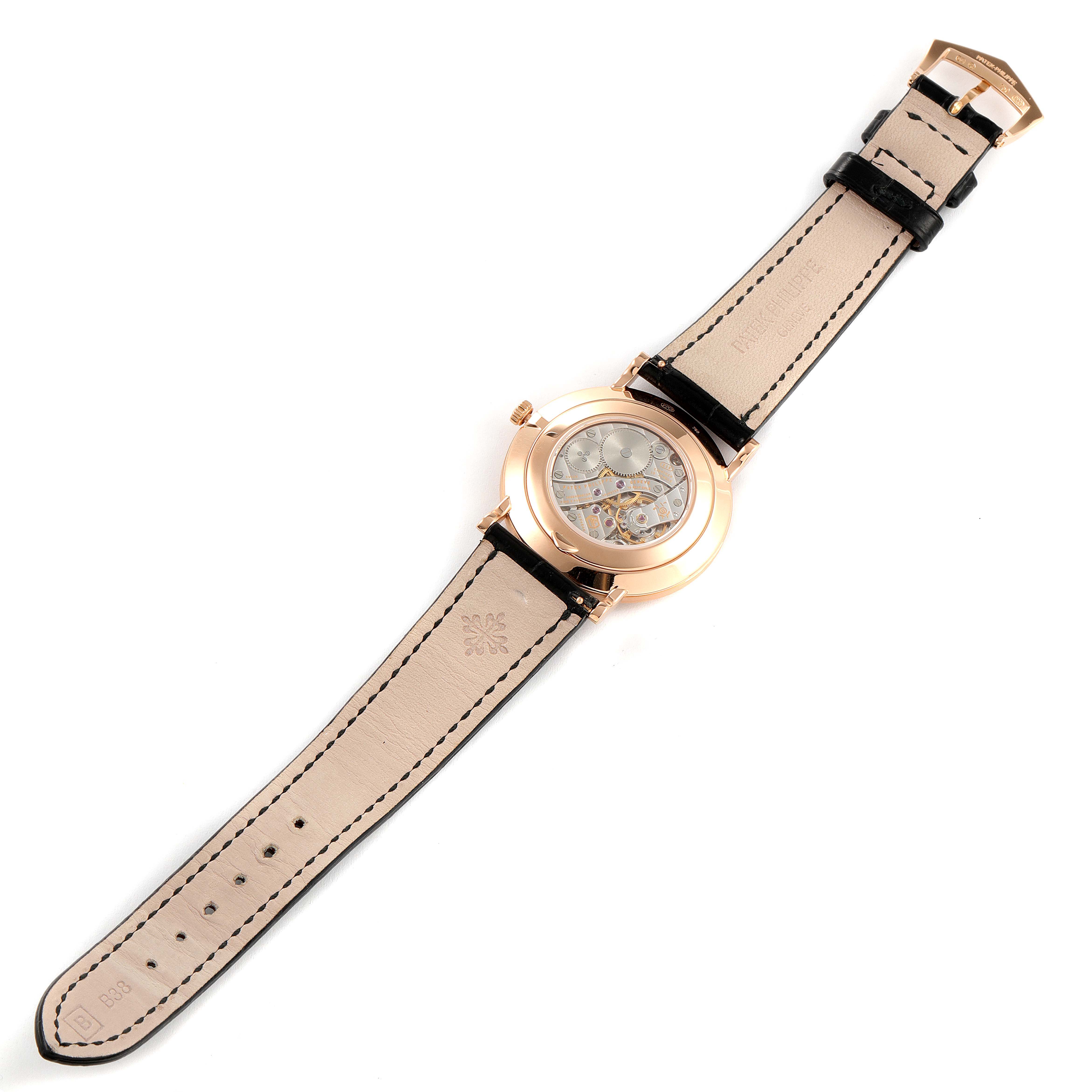 The image shows the back view of a Patek Philippe Calatrava 5119R Men's Rose Gold White Dial 5119R Men's Rose Gold White Dial watch, displaying the open case back and leather strap.