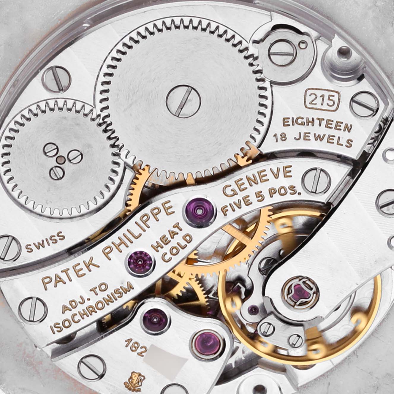 The image shows the intricate movement mechanism of the Patek Philippe Calatrava 3919J Men's Yellow Gold White Dial 3919J Men's Yellow Gold White Dial watch, highlighting gears and jewels.