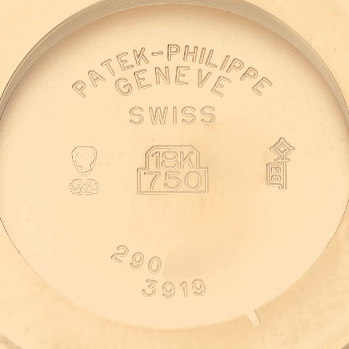 The image shows the back casing of a Patek Philippe Calatrava 3919J Men's Yellow Gold White Dial 3919J Men's Yellow Gold White Dial, featuring a hallmark and "18K 750" stamp.
