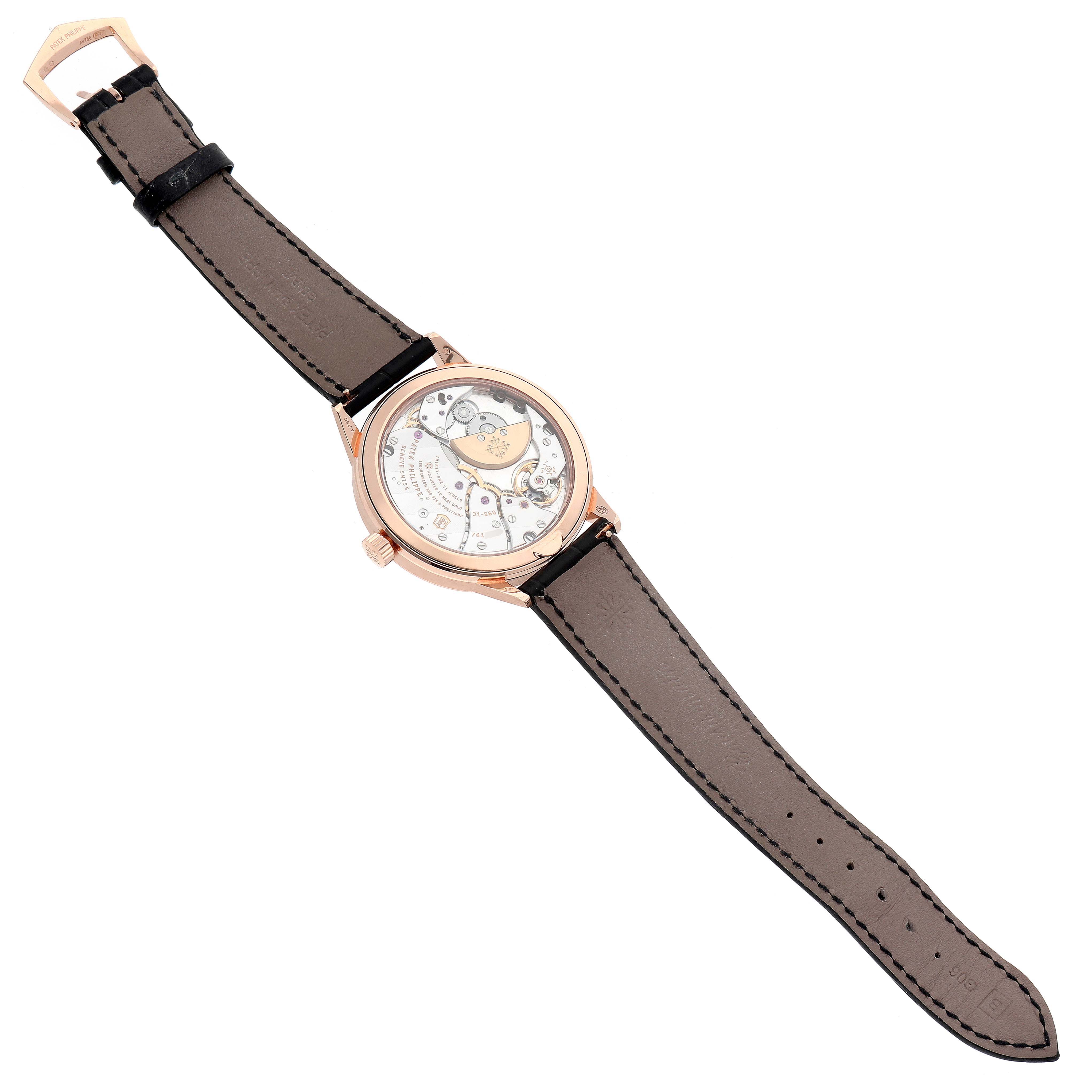 The Patek Philippe Complications 5235/50R-001 Men's Rose Gold Grey Dial watch is shown from a top view, highlighting its transparent case back and leather strap.