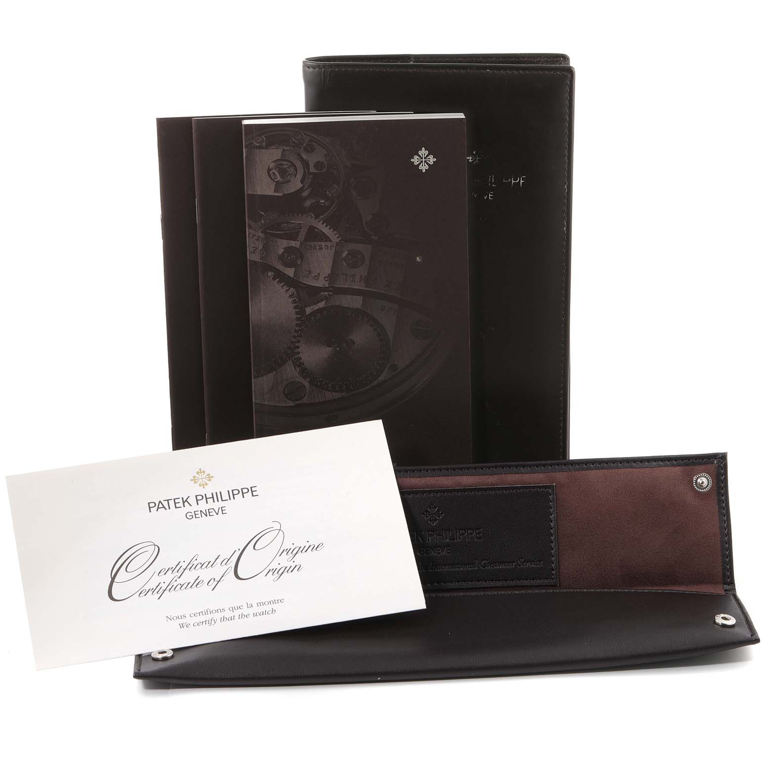 The image shows accessories for the Patek Philippe Gondolo 5098P Men's Platinum Silver Dial 5098P Men's Platinum Silver Dial watch, including a certificate, manuals, and a leather case.