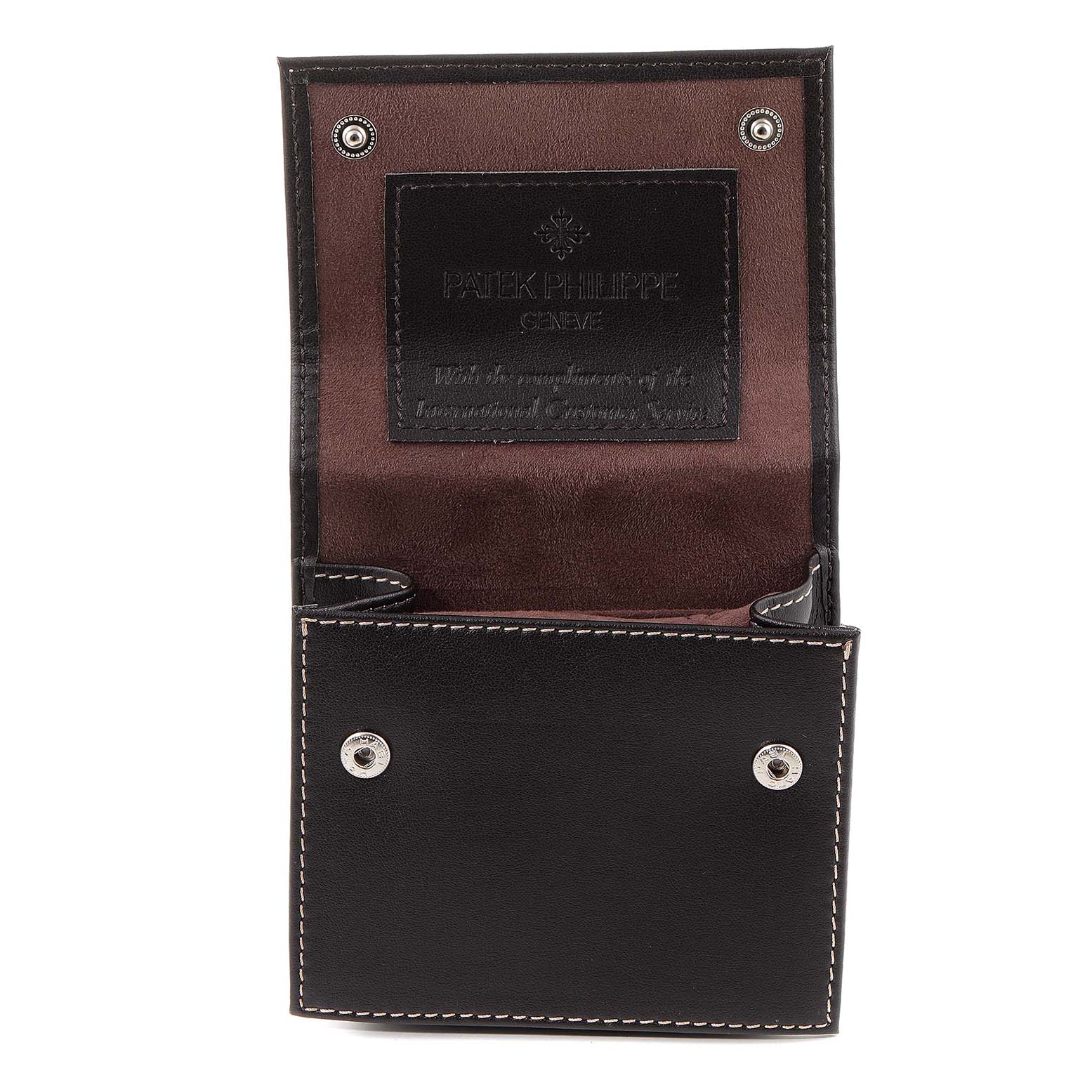 This image shows a Patek Philippe Nautilus 4700/153 Women's Yellow Gold Champagne Dial 4700/153 Women's Yellow Gold Champagne Dial watch leather pouch with open snap buttons, displaying the interior.