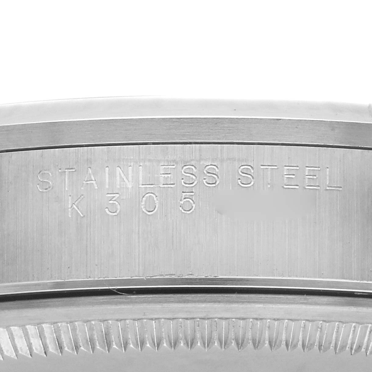 The image shows a close-up of the side of a Rolex Air-King 14000M Men's Stainless Steel Blue Dial 14000M Men's Stainless Steel Blue Dial watch, highlighting the engraved text on the stainless steel surface.