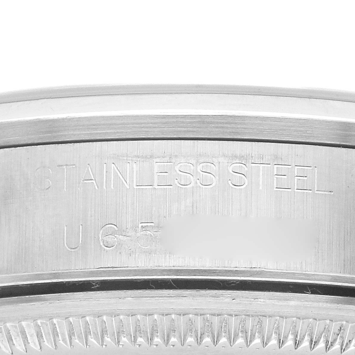 The image shows a close-up of the side engraving on the case of a Rolex Air-King 14000 Men's Stainless Steel Blue Dial 14000 Men's Stainless Steel Blue Dial, highlighting the "STAINLESS STEEL" text.