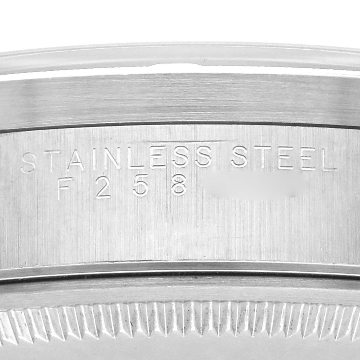 The image shows the side of a Rolex Air-King 14010M Men's Stainless Steel Black Dial 14010M Men's Stainless Steel Black Dial watch case with engraved text indicating "Stainless Steel."