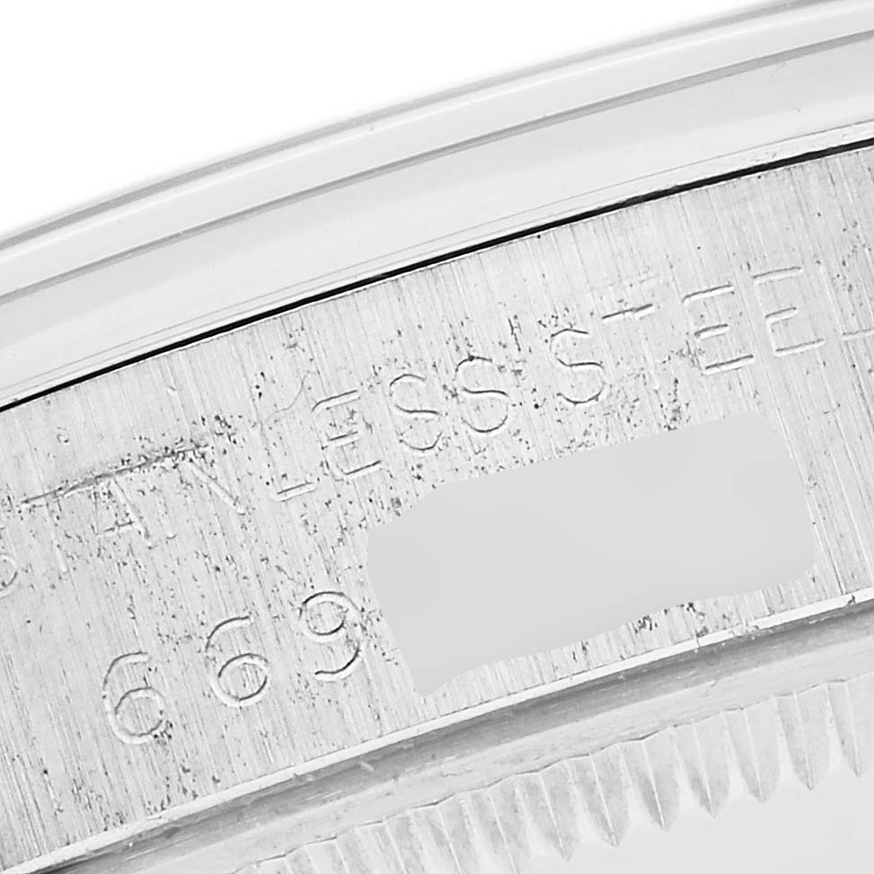 The image shows an engraving on the steel part of a Rolex Air-King 5500 Men's Stainless Steel Silver Dial 5500 Men's Stainless Steel Silver Dial watch from a close-up angle.