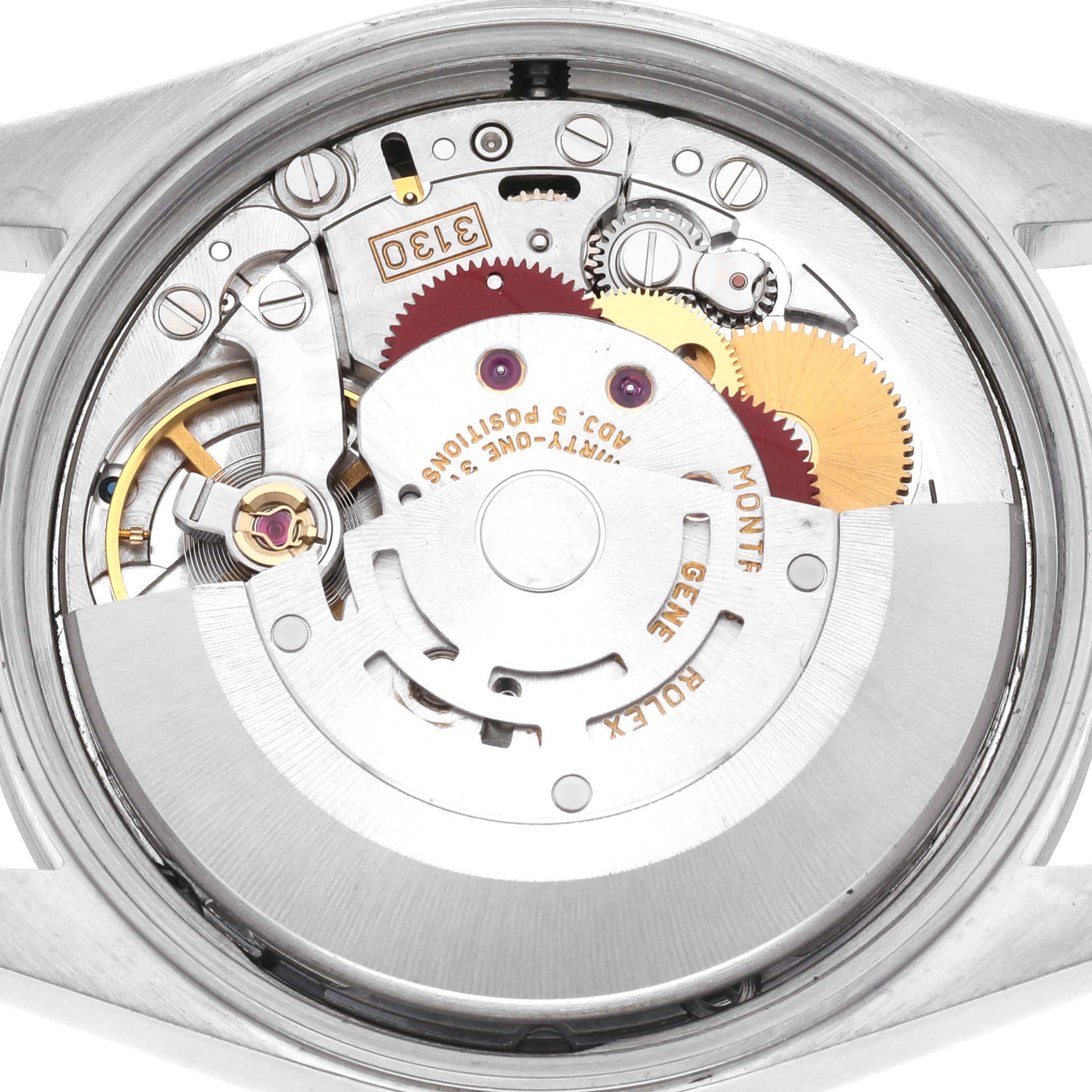 The image shows the internal mechanism of a Rolex Air-King 14000M Men's Stainless Steel Silver Dial 14000M Men's Stainless Steel Silver Dial watch from a back angle, highlighting gears and components.