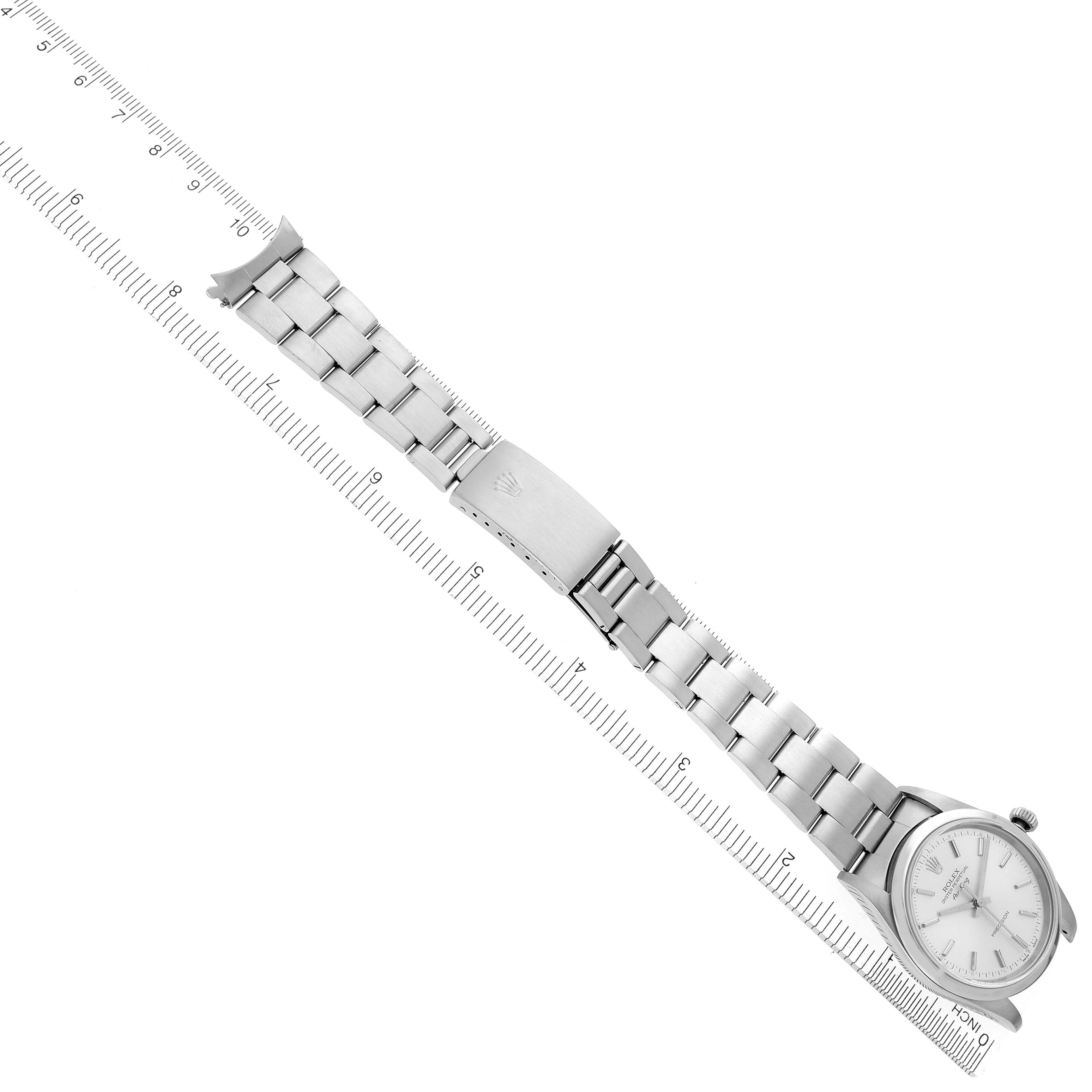 The Rolex Air-King 14000M Men's Stainless Steel Silver Dial 14000M Men's Stainless Steel Silver Dial watch is shown from a side angle, highlighting its face and metal bracelet aligned with a ruler.