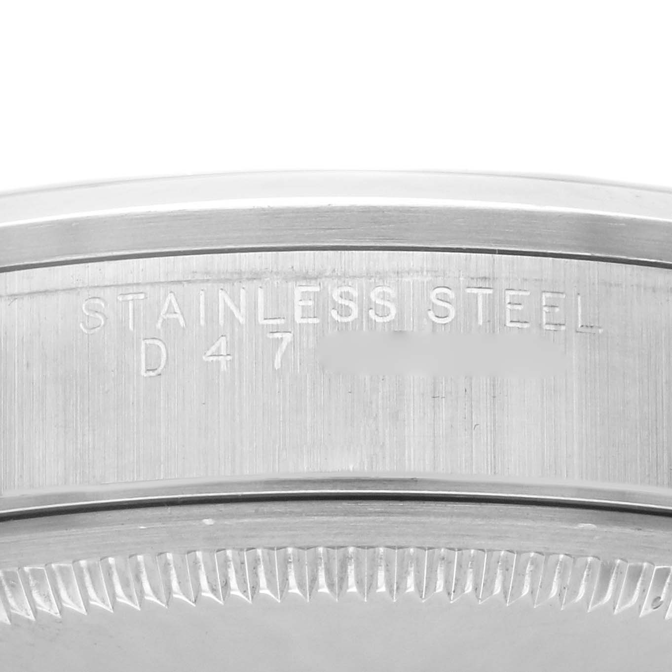 The image shows an angled view of the stainless steel case back of a Rolex Air-King 14000M Men's Stainless Steel Silver Dial 14000M Men's Stainless Steel Silver Dial watch with engraved text.