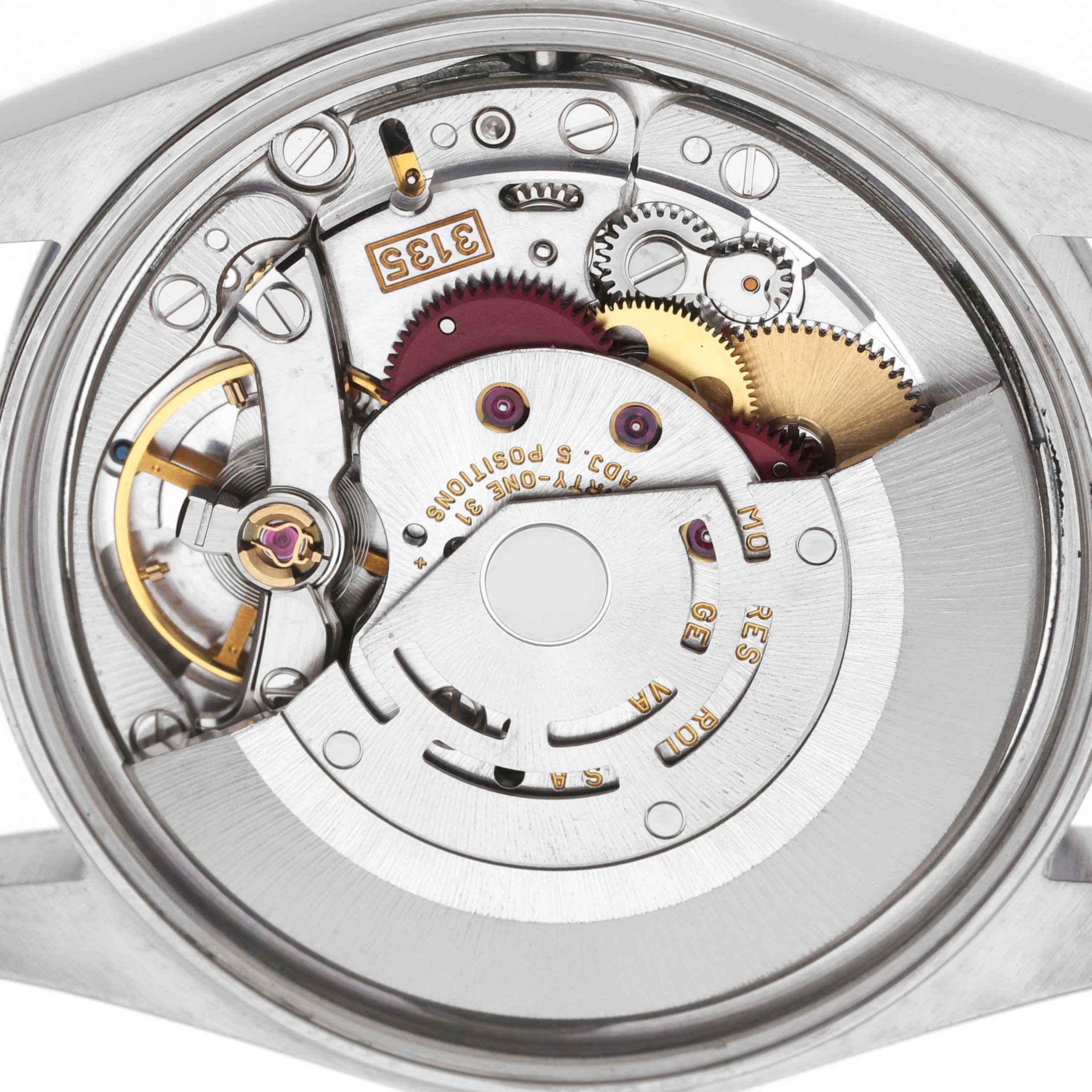 The image shows the movement of a Rolex Date 15200 Men's Stainless Steel Black Dial model, focusing on gears and mechanism from the back.