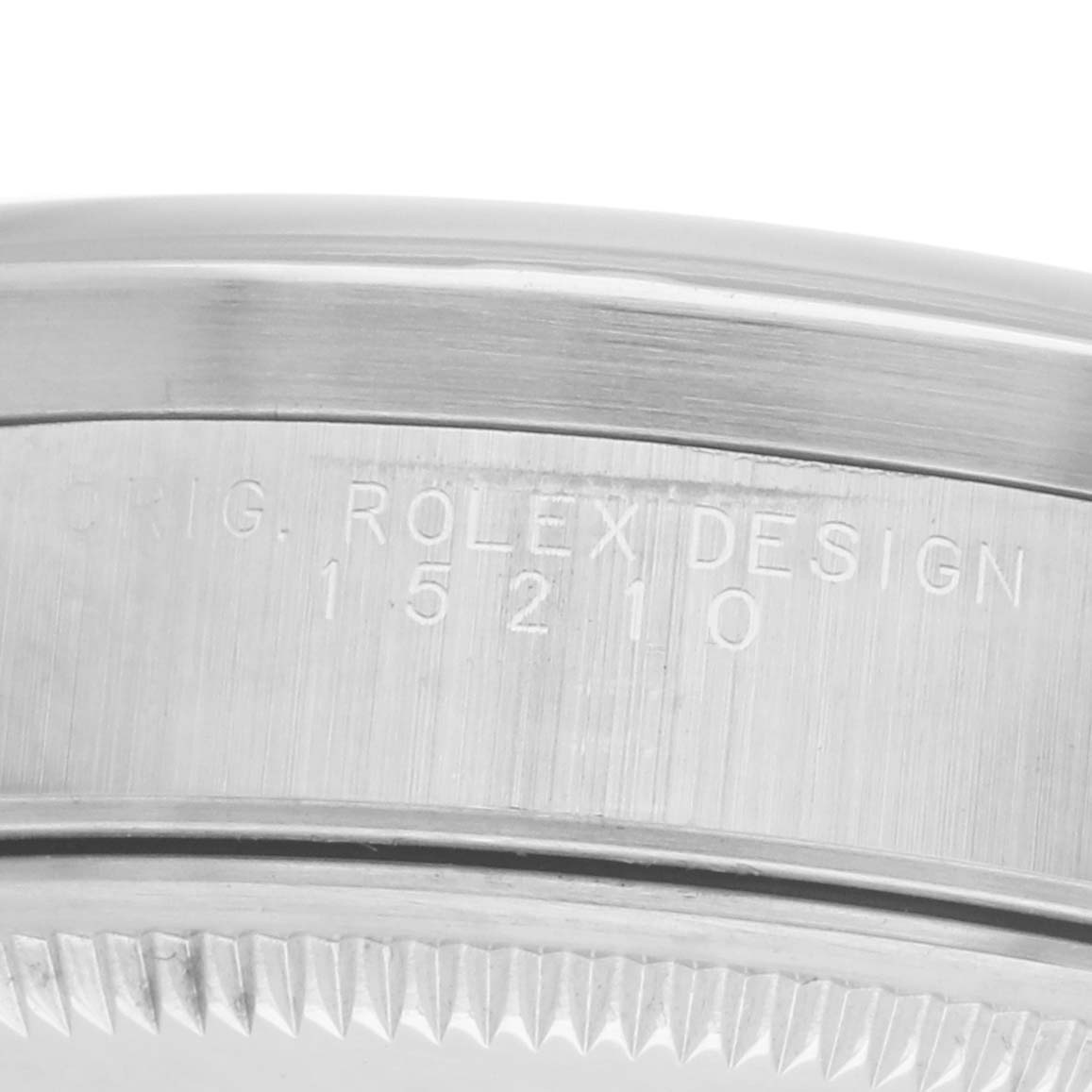 The image shows a close-up of the side of a Rolex Date 15210 Men's Stainless Steel Silver Dial model watch, featuring engravings and the bezel edge.