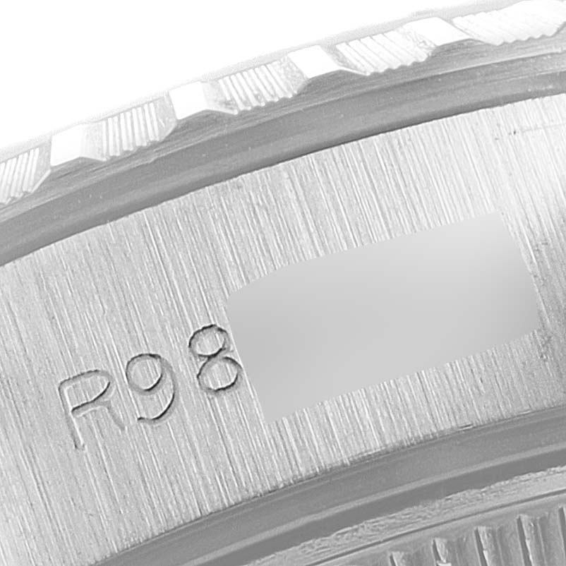 This close-up image shows the side of the bezel and case of a Rolex Date 69240 Women's Stainless Steel Silver Dial 69240 Women's Stainless Steel Silver Dial model watch.