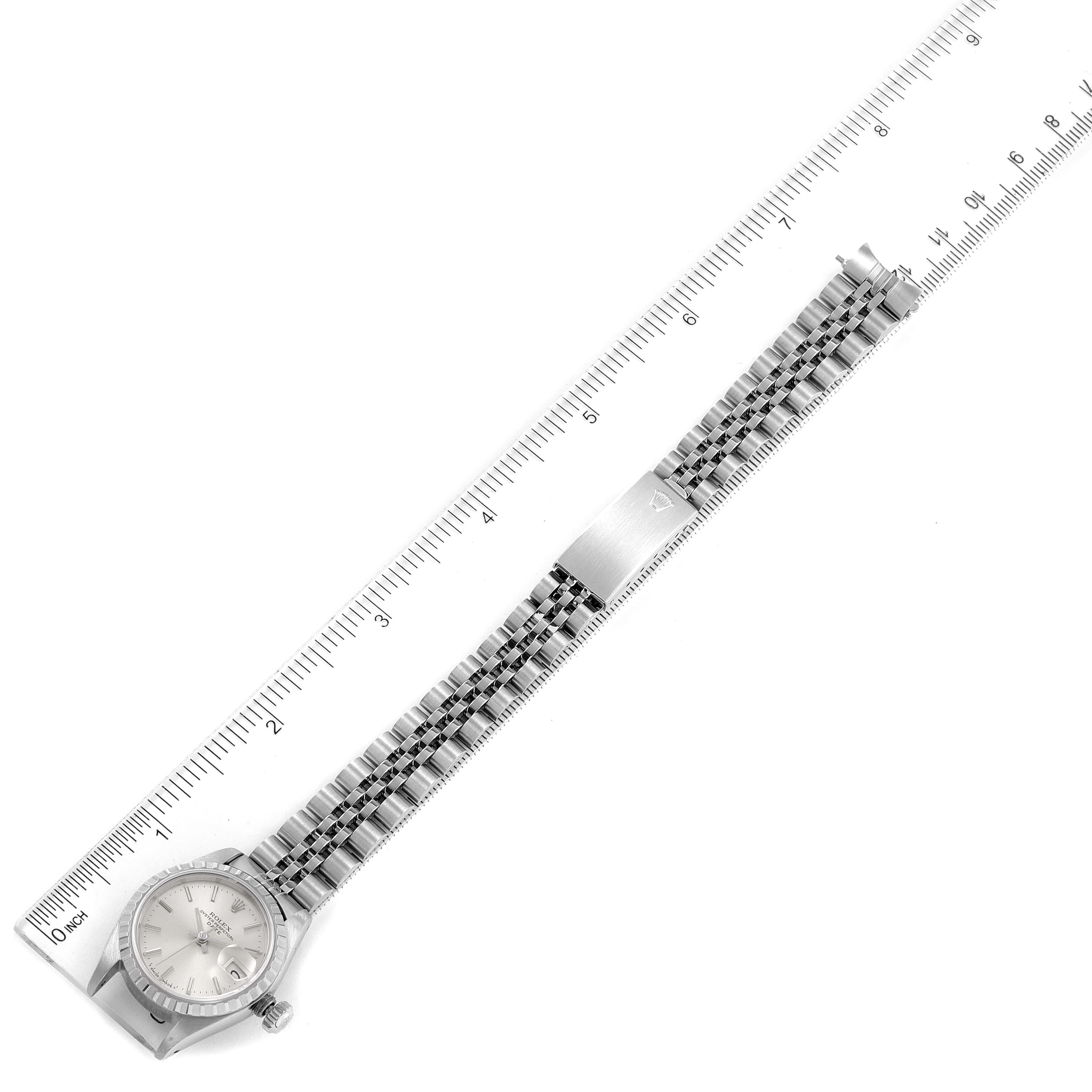 The image shows a Rolex Date 69240 Women's Stainless Steel Silver Dial 69240 Women's Stainless Steel Silver Dial model watch laid flat next to a ruler, displaying the full face and bracelet.