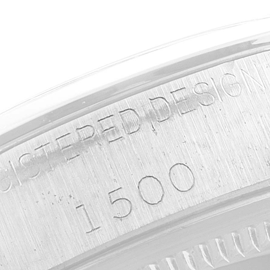 The image shows a close-up of the engraved serial numbers and text on the casing edge of a Rolex Date 1500 Men's Stainless Steel Silver Dial 1500 Men's Stainless Steel Silver Dial model watch.