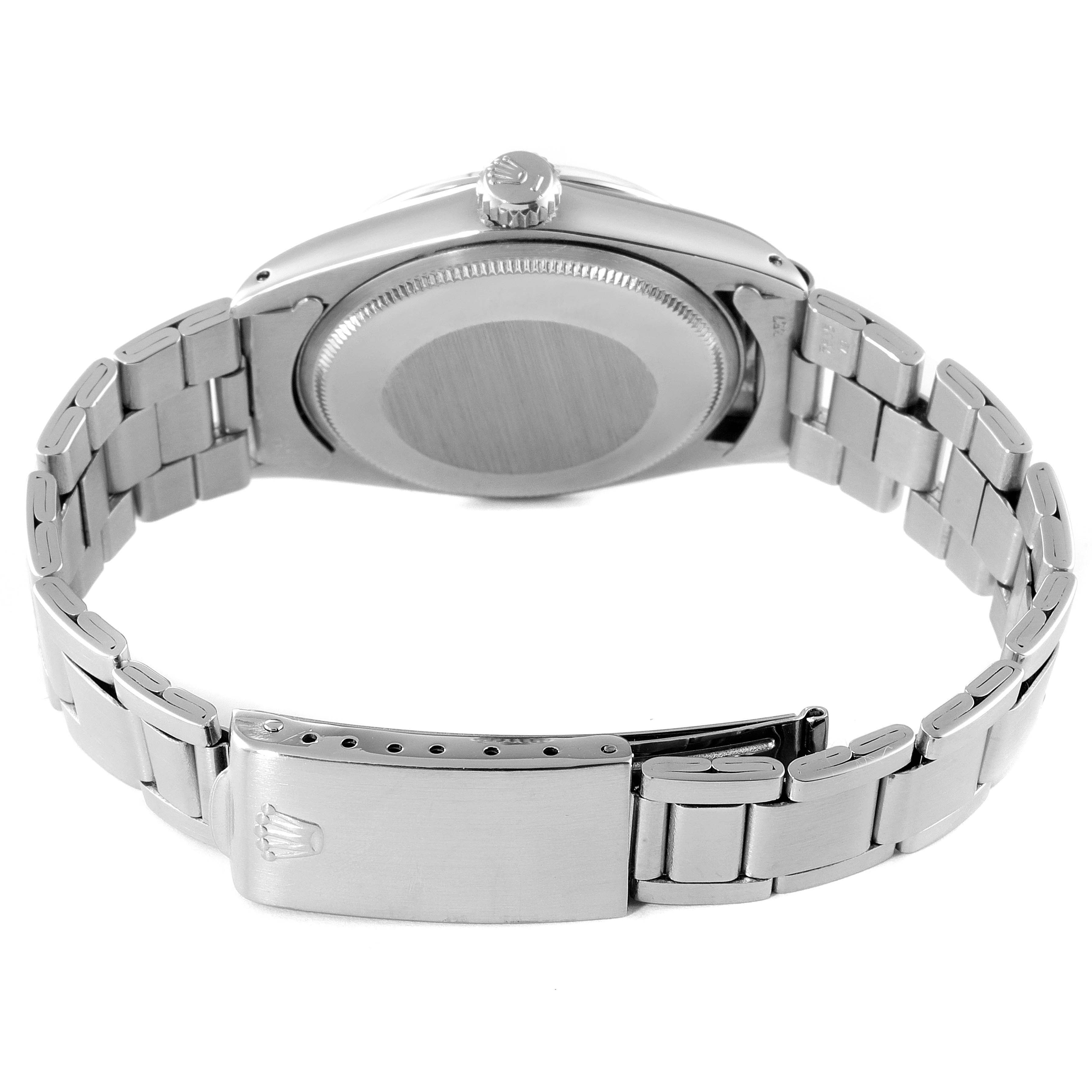 The image shows the back of a Rolex Date 1500 Men's Stainless Steel Silver Dial 1500 Men's Stainless Steel Silver Dial model watch, featuring the case back, crown, and the bracelet with a closed clasp.
