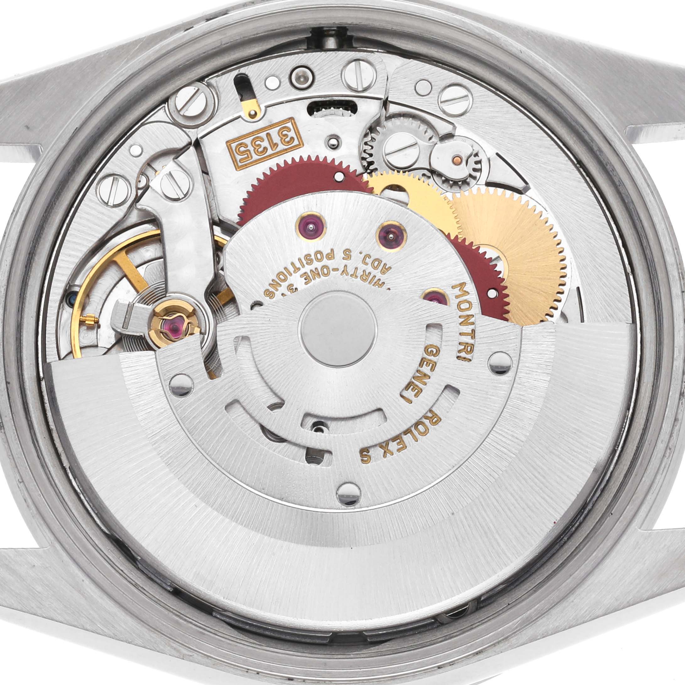 The image shows the movement interior of a Rolex Date 15210 Men's Stainless Steel White Dial 15210 Men's Stainless Steel White Dial model, featuring gears and the rotor from the back.