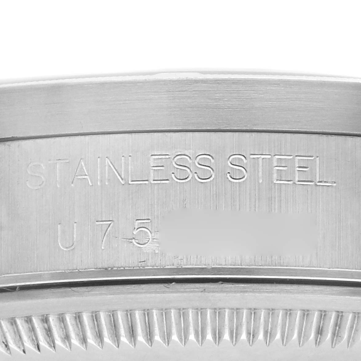 The image shows a close-up of the engraved stainless steel case back of a Rolex Date 15210 Men's Stainless Steel White Dial 15210 Men's Stainless Steel White Dial watch.