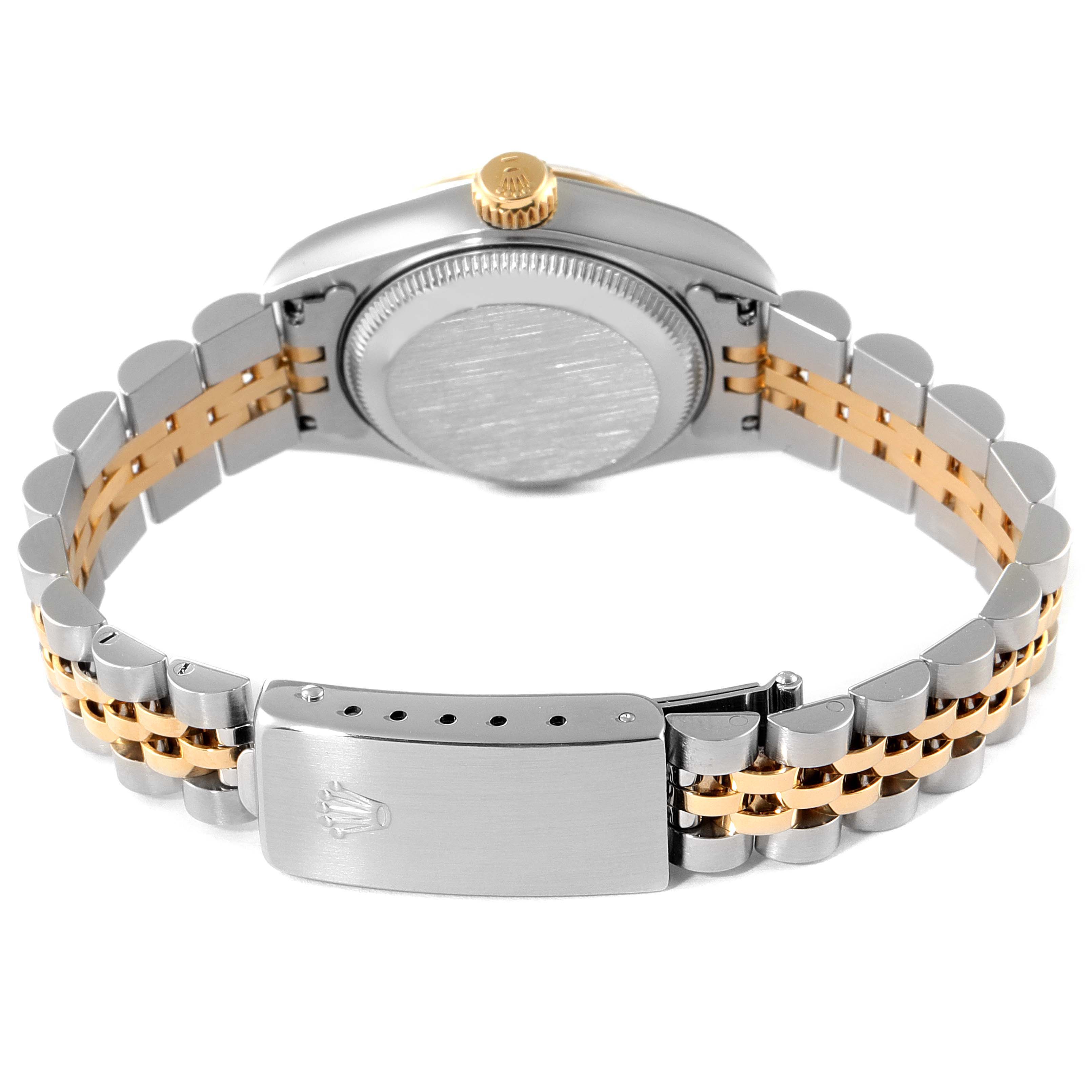 This image shows the backside of the Rolex Datejust 69173 Women
s Steel and Gold (two tone) Champagne Dial 69173 Women
s Steel and Gold (two tone) Champagne Dial watch, featuring its case back, crown, and bicolored Jubilee bracelet with the clasp.