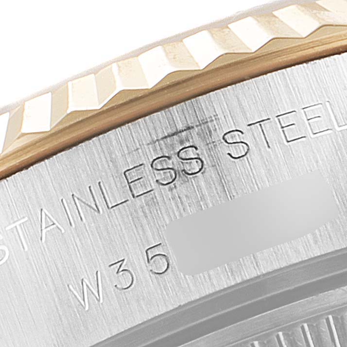 This image shows a close-up of the side engraving and fluted bezel of a Rolex Datejust 69173 Women
s Steel and Gold (two tone) Champagne Dial 69173 Women
s Steel and Gold (two tone) Champagne Dial watch.
